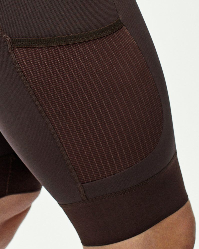 Side cargo pocket with tilted opening and grid mesh panel on cycling shorts