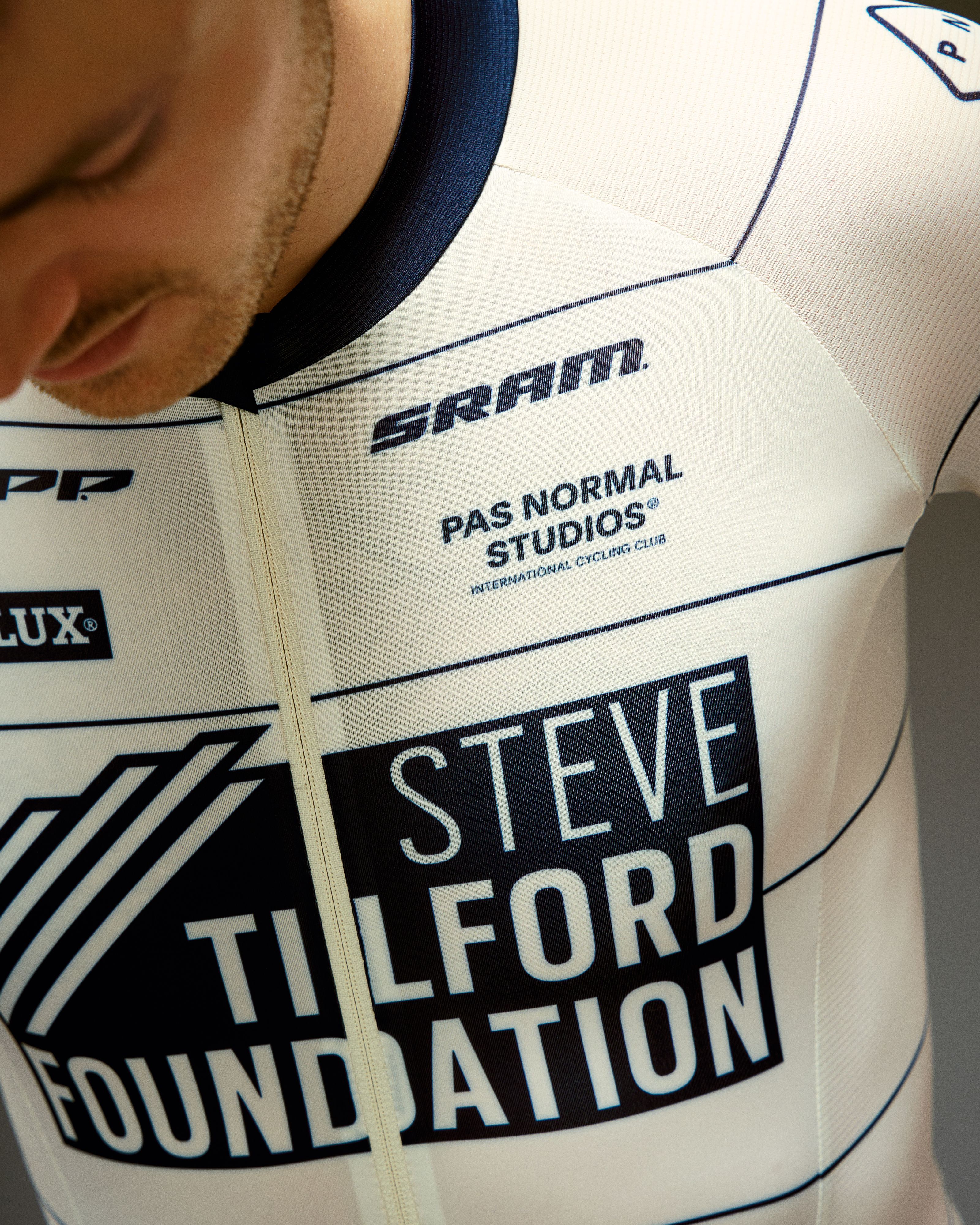 Off White STFR Mechanism speedsuit on model showing Steve Tilford Foundation sponsor graphics