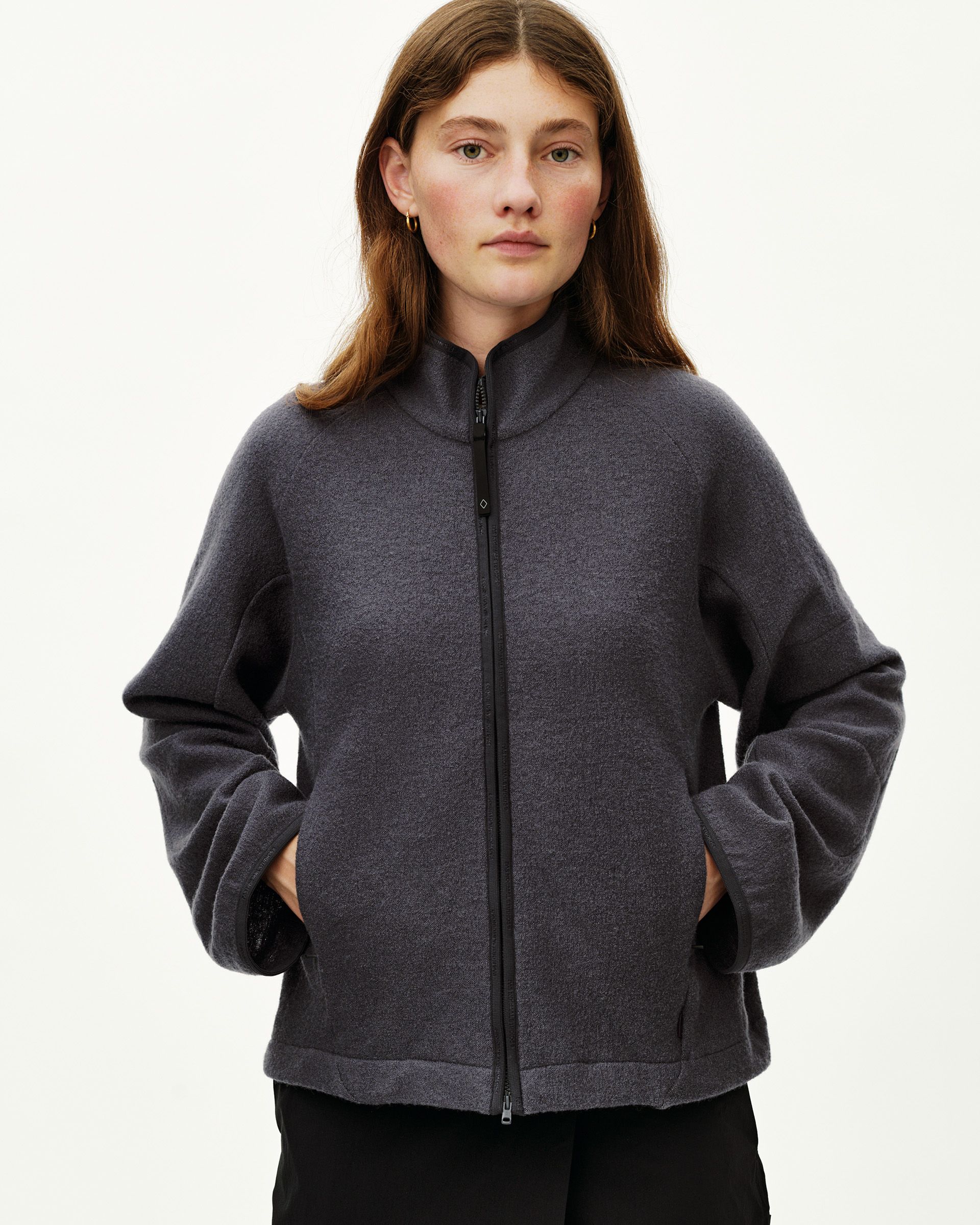 Steel grey Off-Race Boiled Wool jacket on model, front view with full zip and mock neck collar