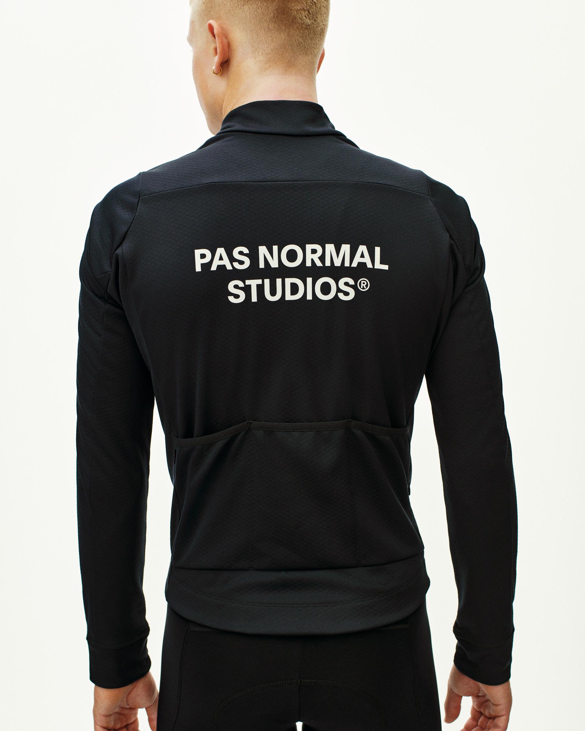 Black Essential thermal long sleeve cycling jersey, rear view on model with white back logo