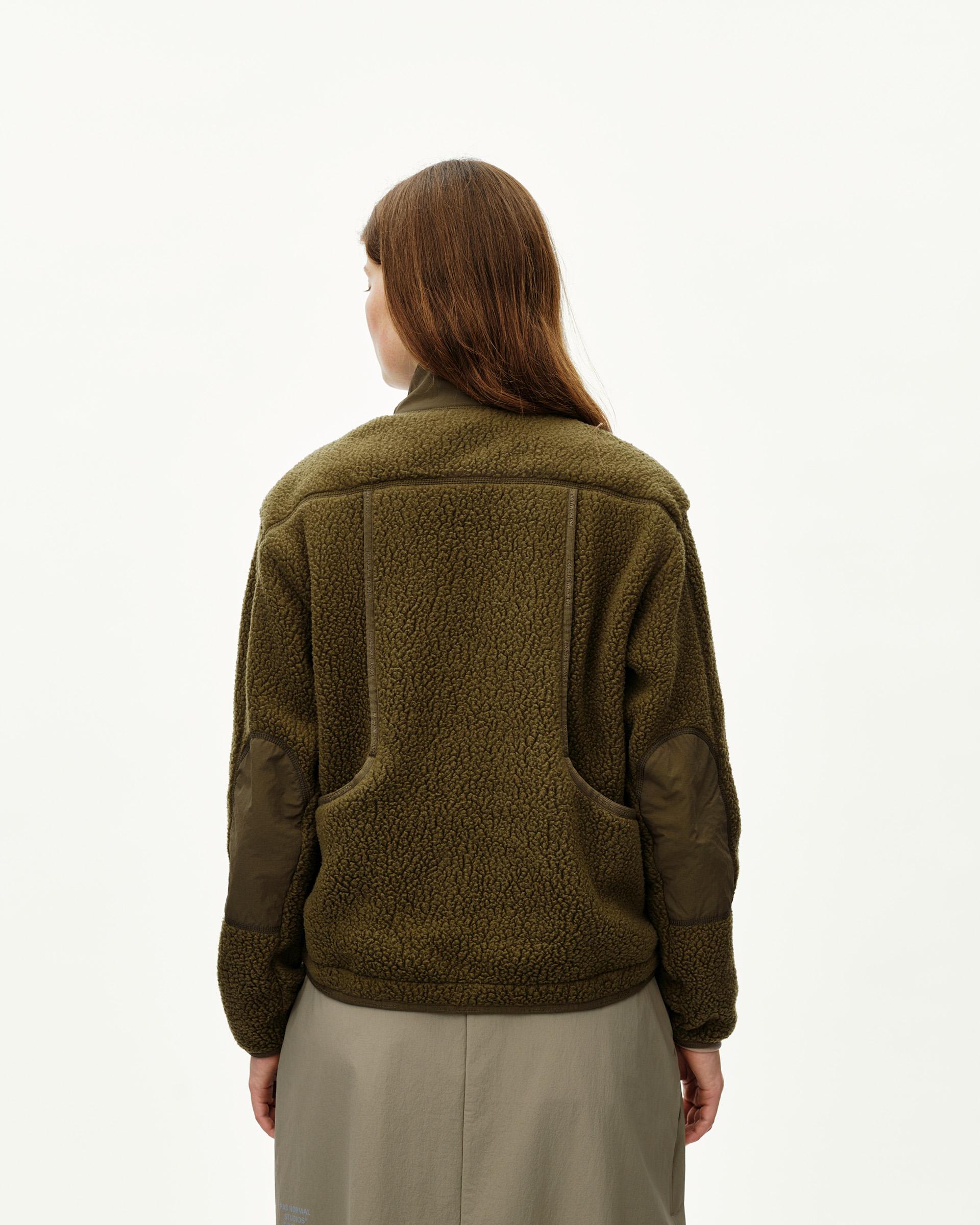 Deep Olive Off-Race Pile Fleece jacket on model, rear view with contrast nylon elbow patches and hem panels