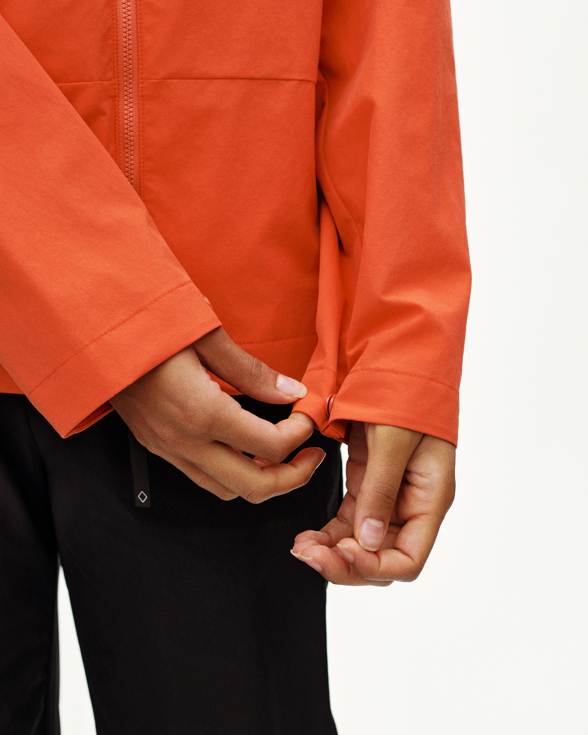 Orange Off-Race Utility jacket on model showing zip closure and cuff detail