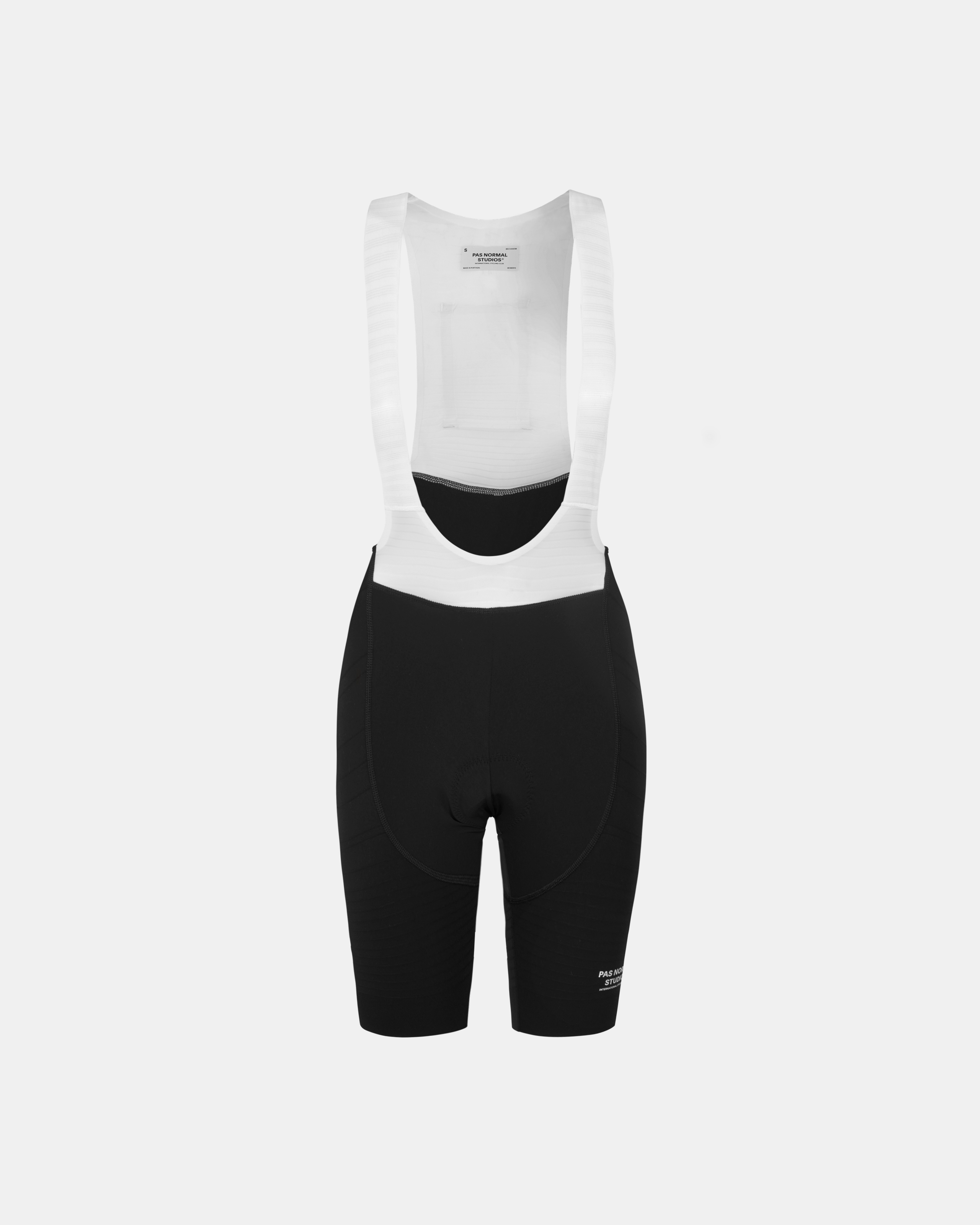 Black Mechanism Pro cycling bibs, front flat lay with white shoulder straps