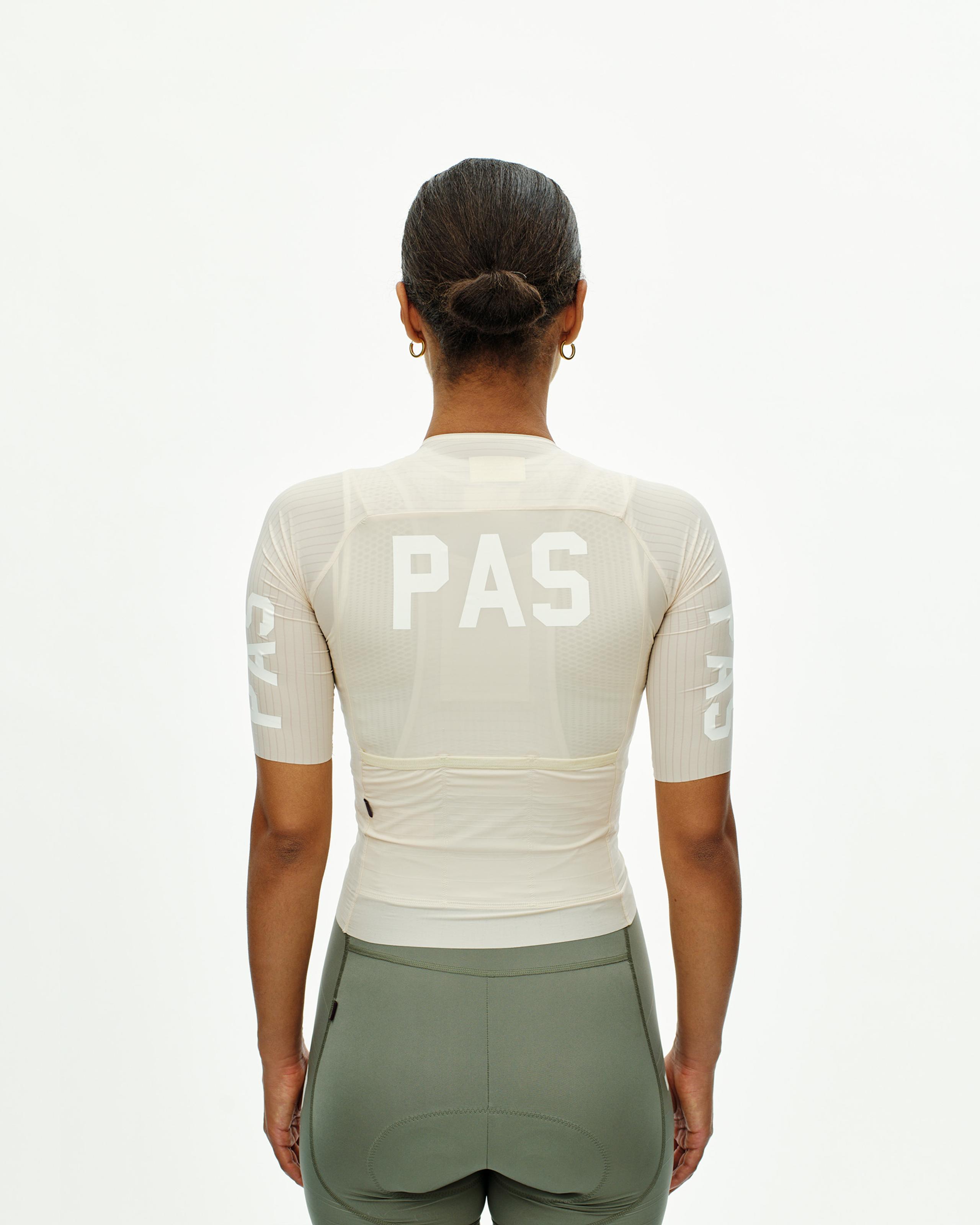 Cream PAS Mechanism Pro cycling jersey, rear view on model with white PAS logo and ribbed sleeves