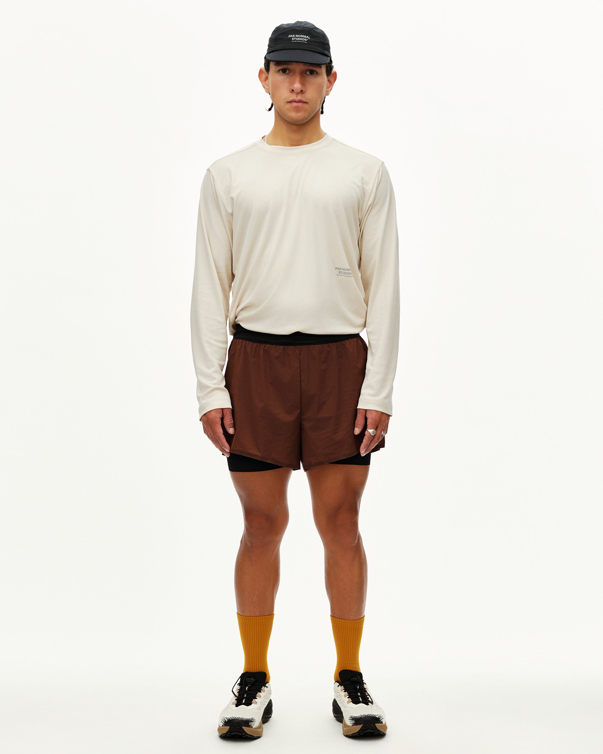 Maroon Brown Balance 2-in-1 shorts on model, front view with black inner liner visible at hem
