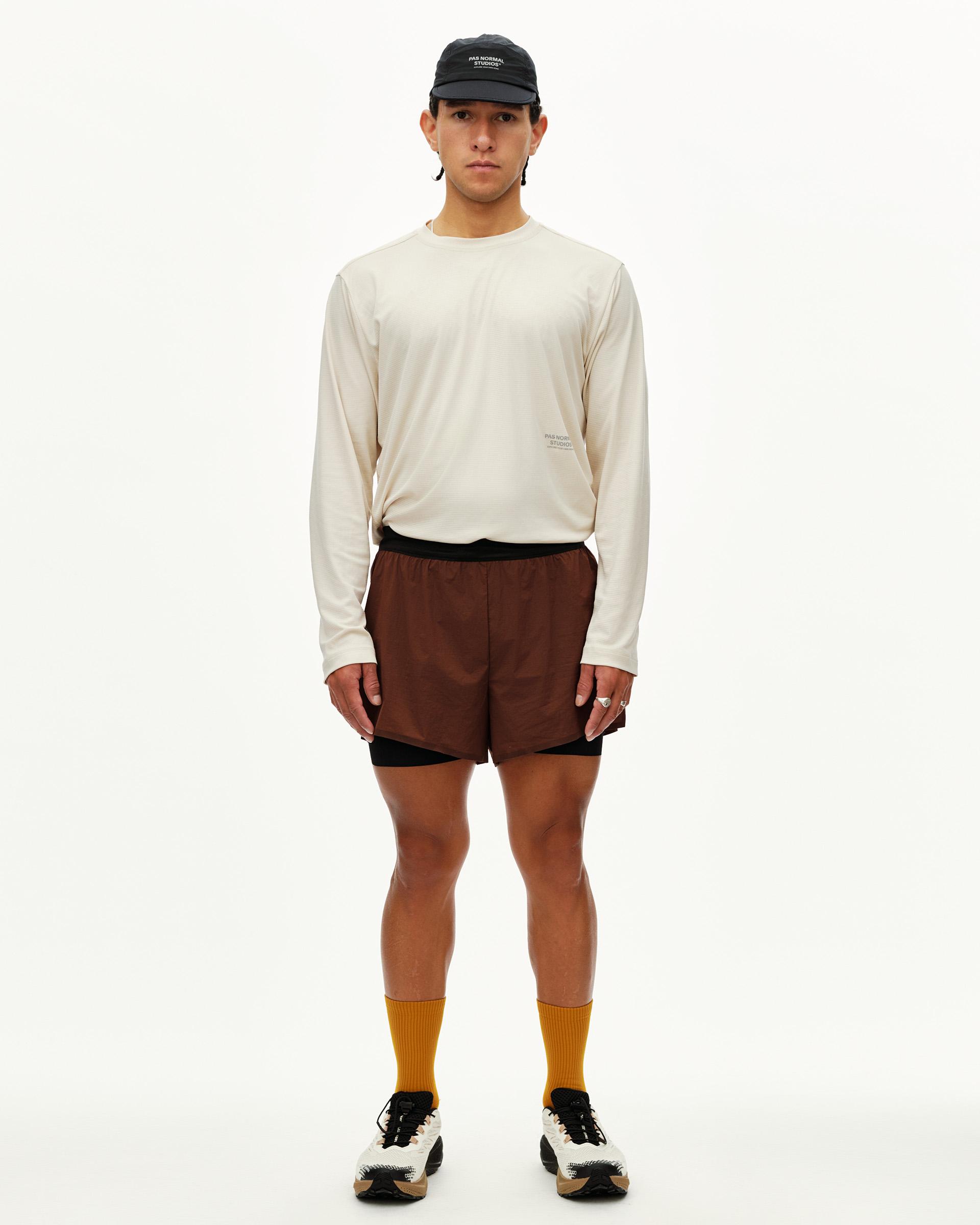 Maroon Brown Balance 2-in-1 shorts on model, front view with black inner liner visible at hem