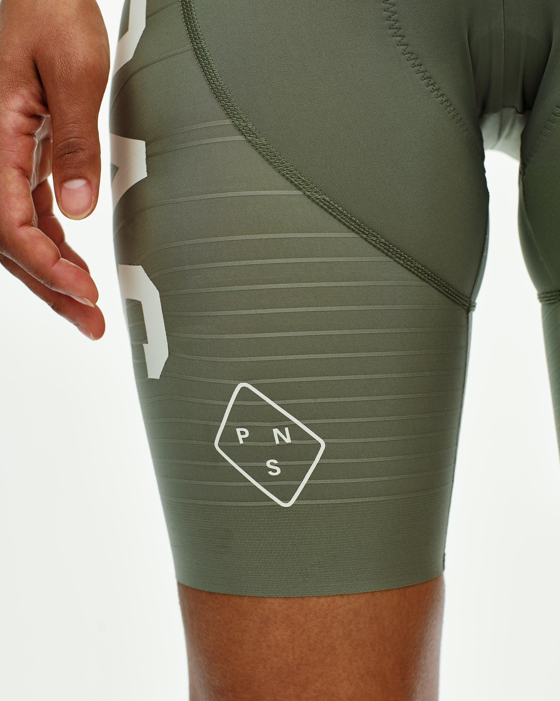 Grey PAS Mechanism Pro bibs on model with horizontal ribbed leg bands and contrast stitching
