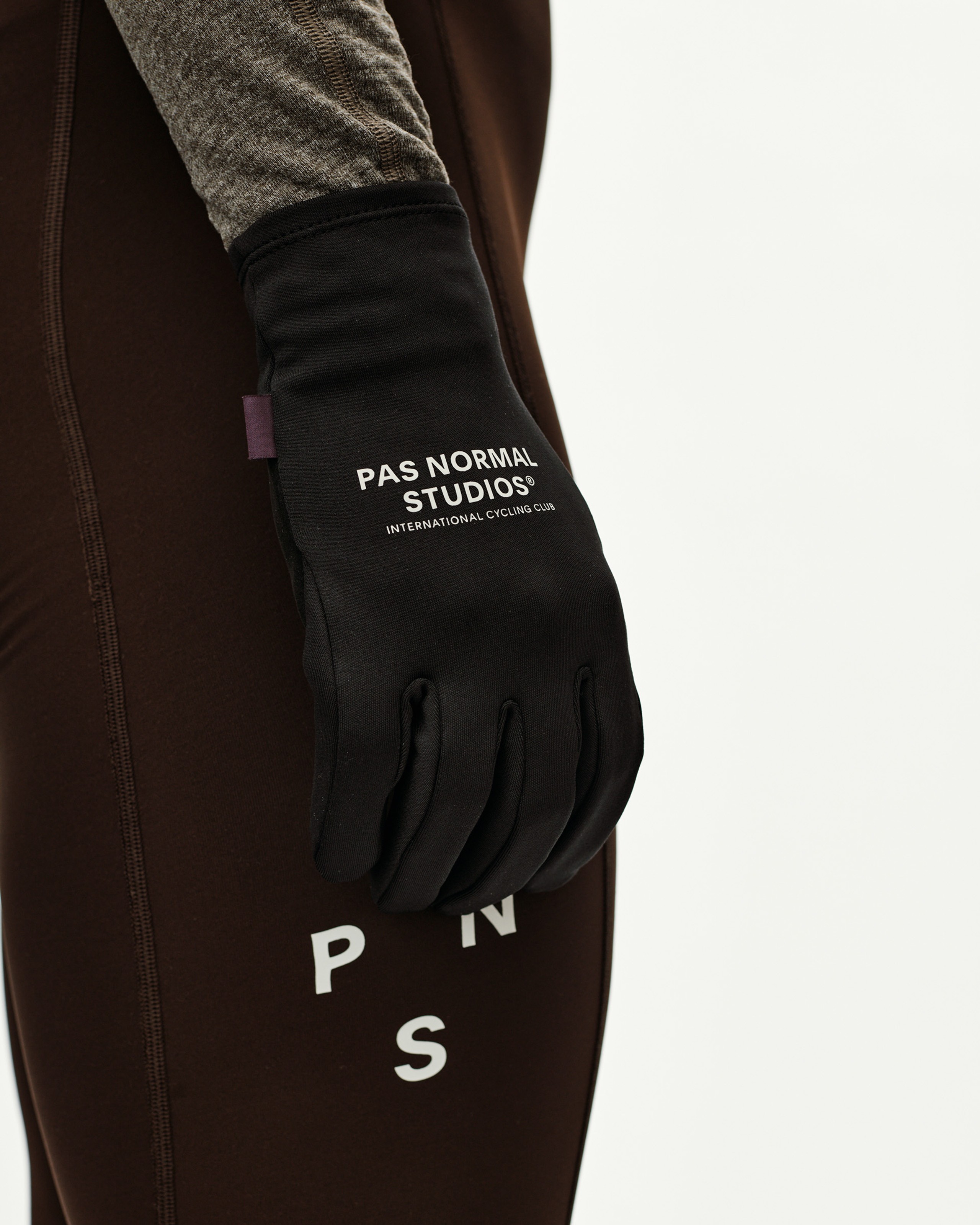 Black Logo Light cycling glove on model, side view with white chest print on back of hand