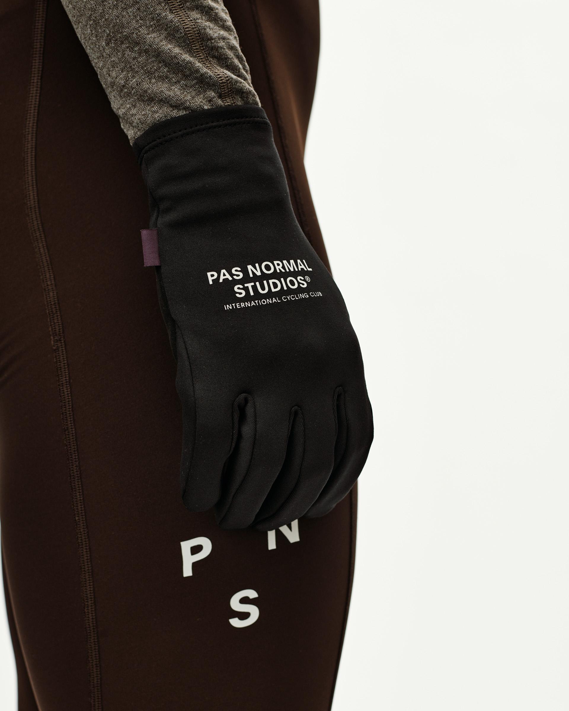 Black Logo Light cycling glove on model, side view with white chest print on back of hand