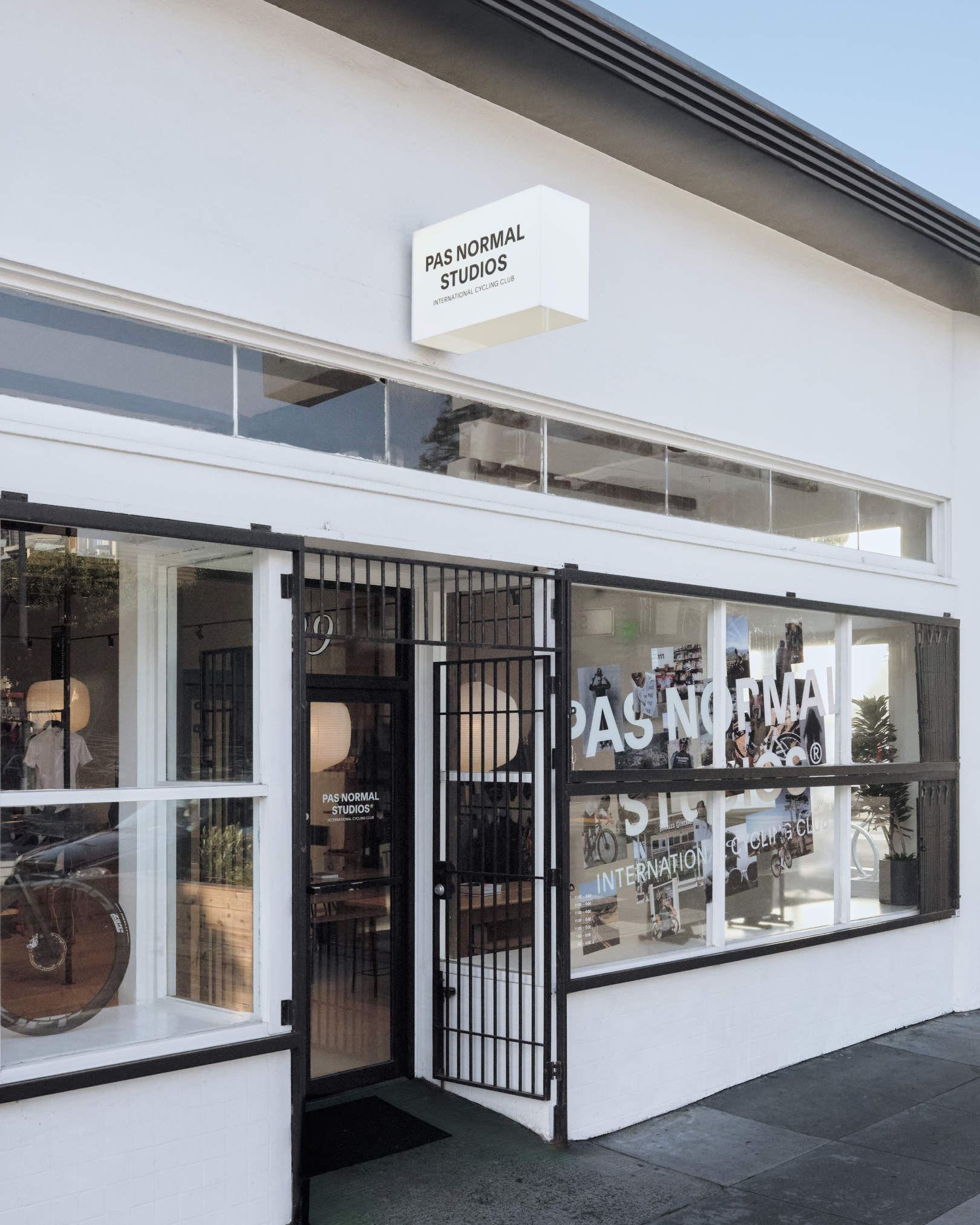 Brand store exterior in San Francisco with white facade and black metal security gates