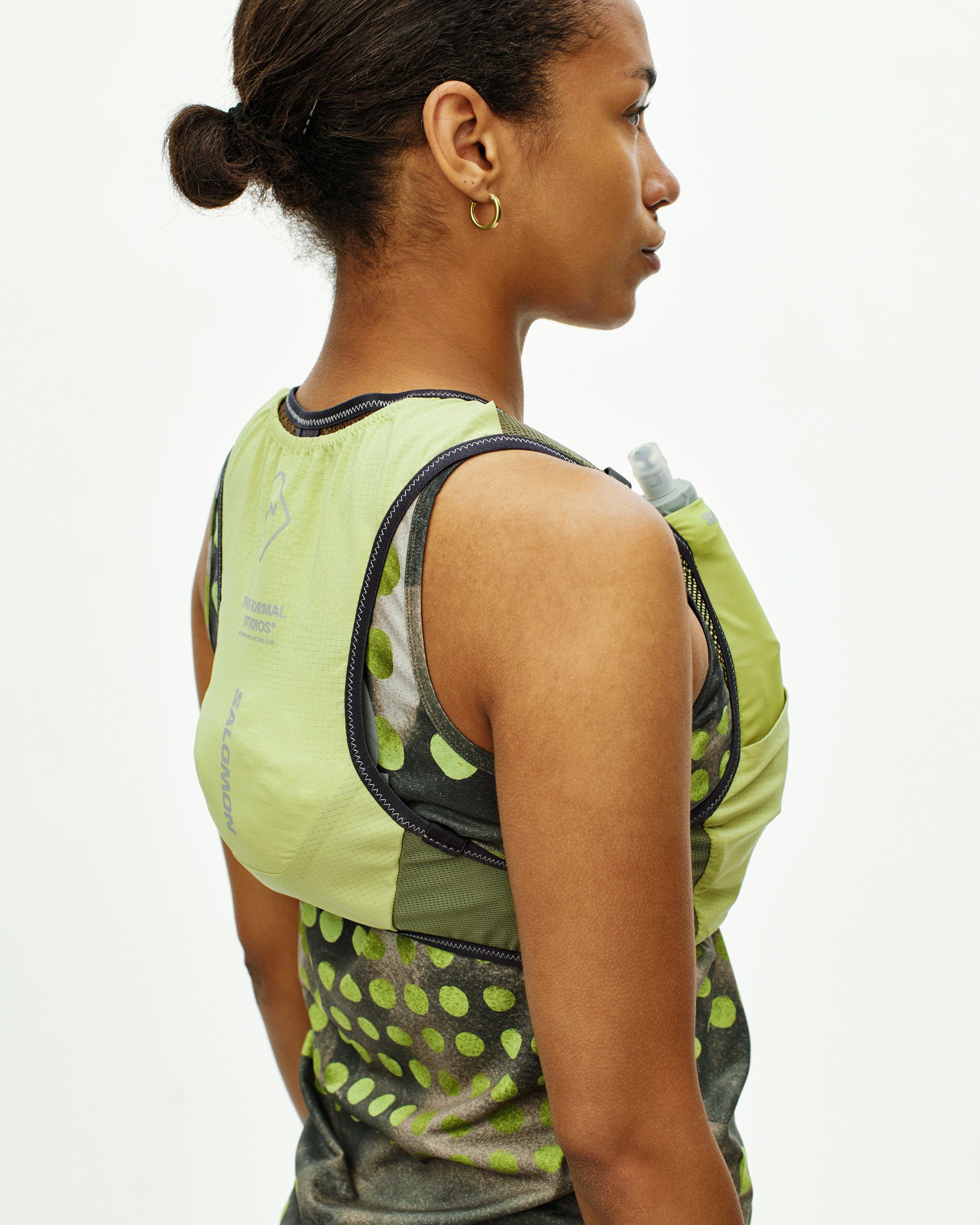 Green Salomon Race Skin 2 vest on model, side view with hydration bladder