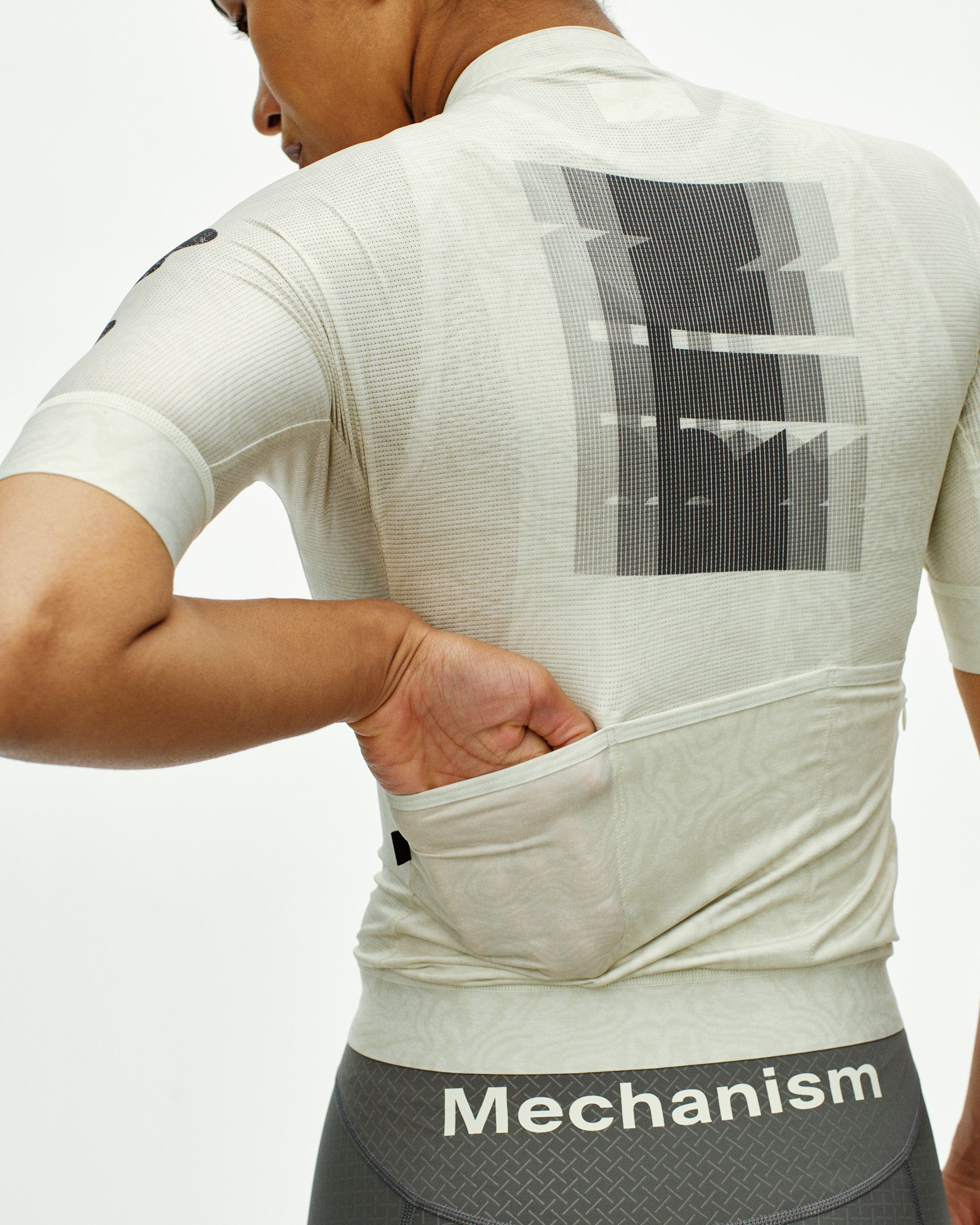 Off White Mechanism cycling jersey on model, rear view with graphic back print and hand in rear pocket