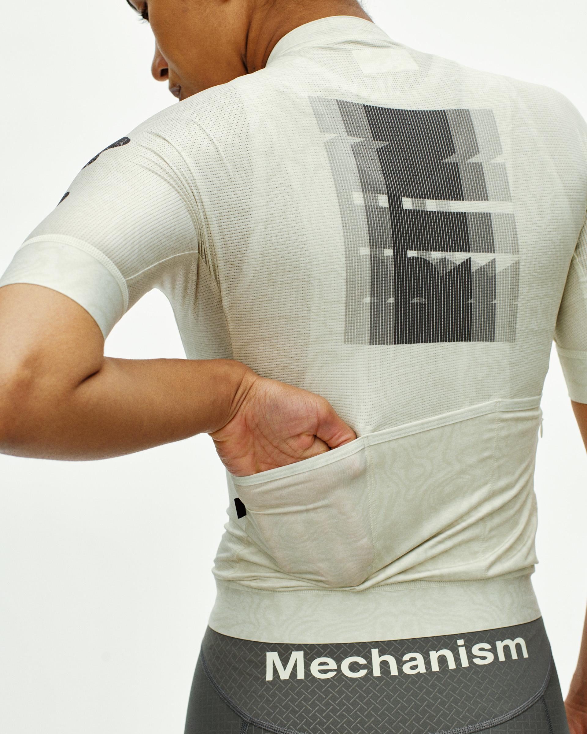 Off White Mechanism cycling jersey on model, rear view with graphic back print and hand in rear pocket