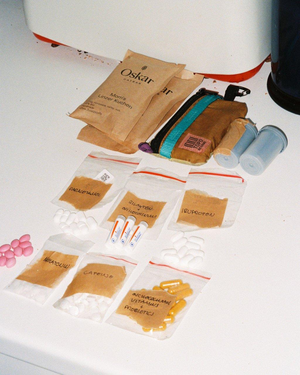 Natural dye samples and materials spread on white surface with glass vials and testing supplies