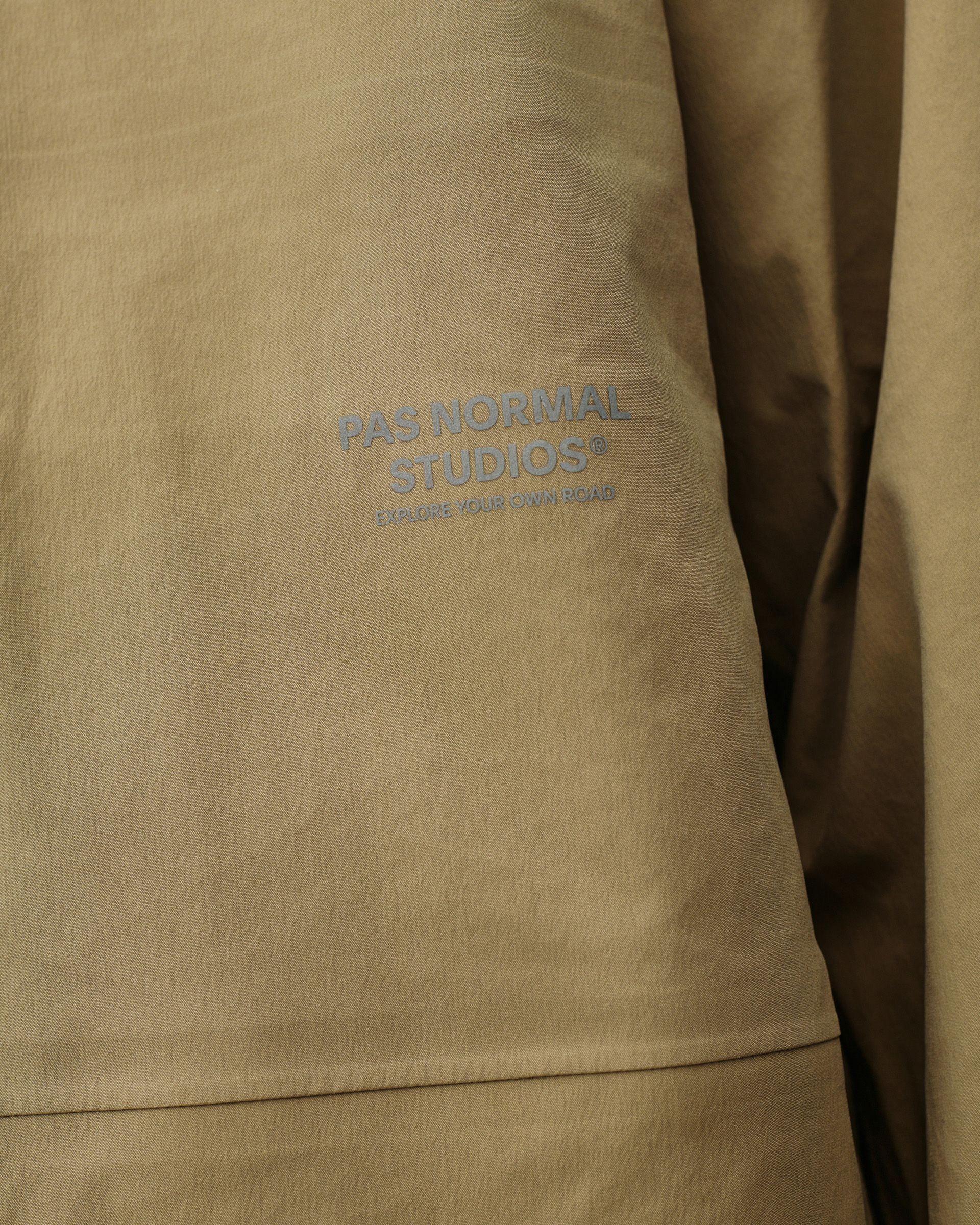 Brown Off-Race 3L Shell jacket, detail view of chest logo print on woven shell fabric
