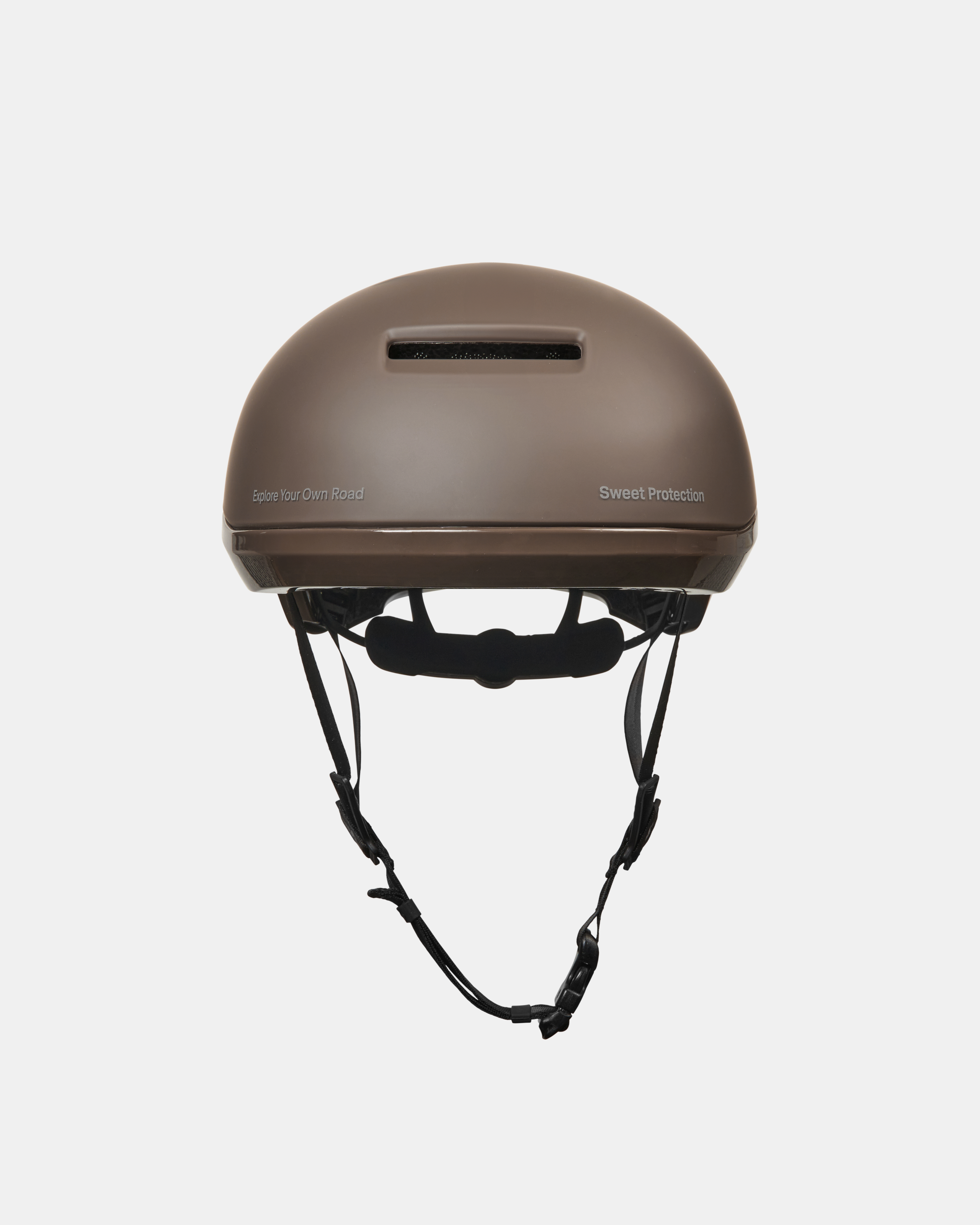 Brown Sweet Protection Commuter Mips cycling helmet, front view with ventilation slot and adjustment system