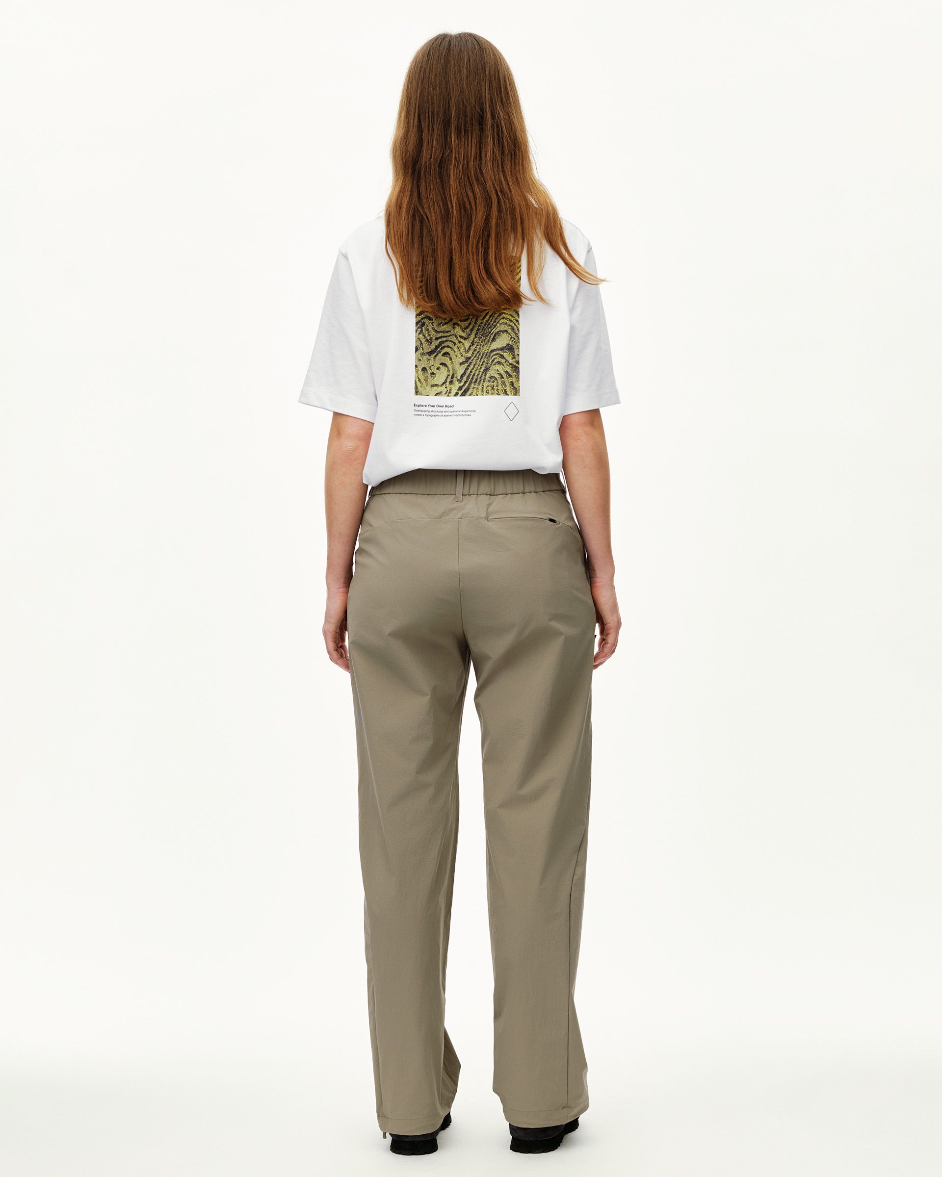 Dusty Earth khaki Off-Race Tech women's pants, rear view on model with zip back pocket