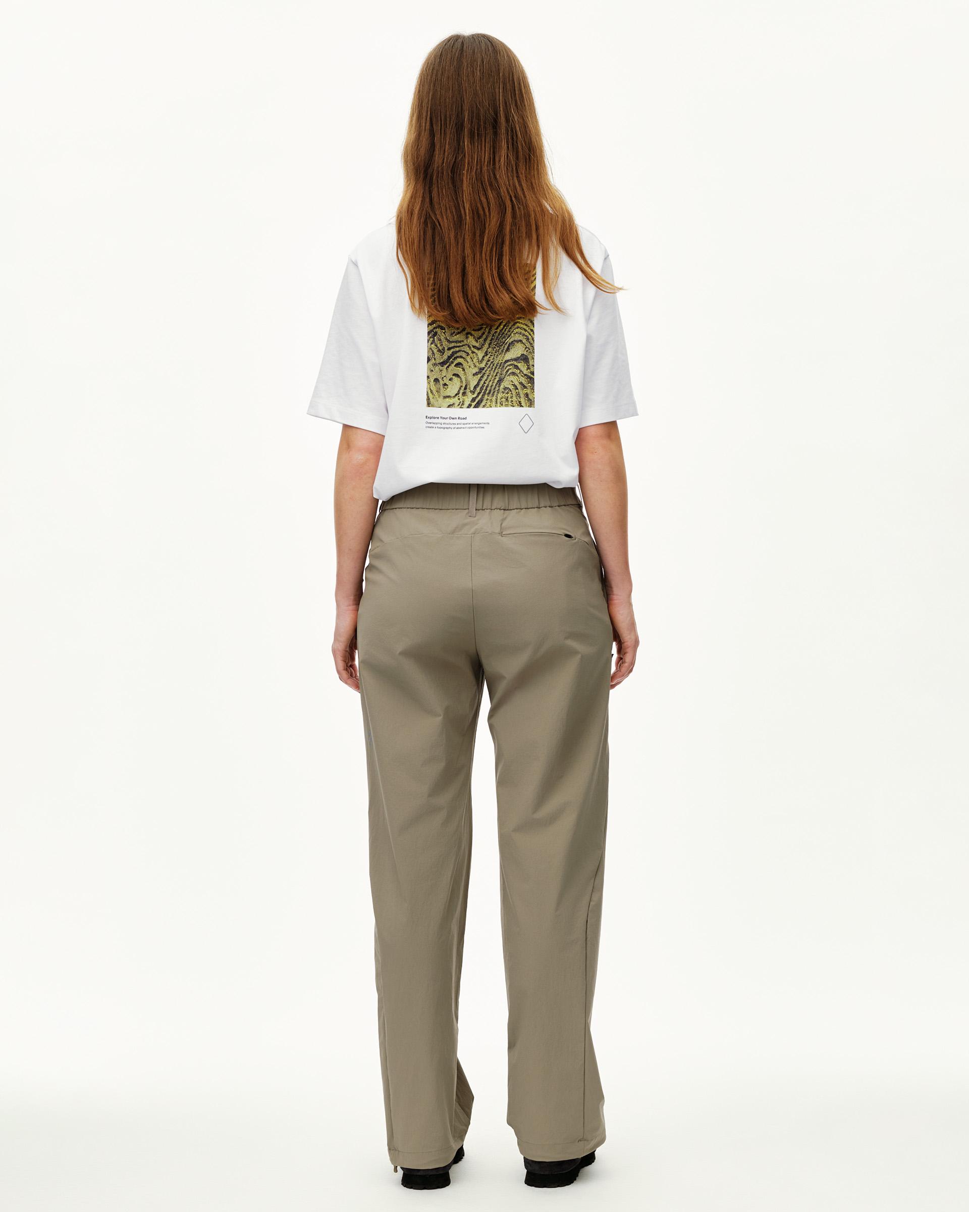 Dusty Earth khaki Off-Race Tech women's pants, rear view on model with zip back pocket