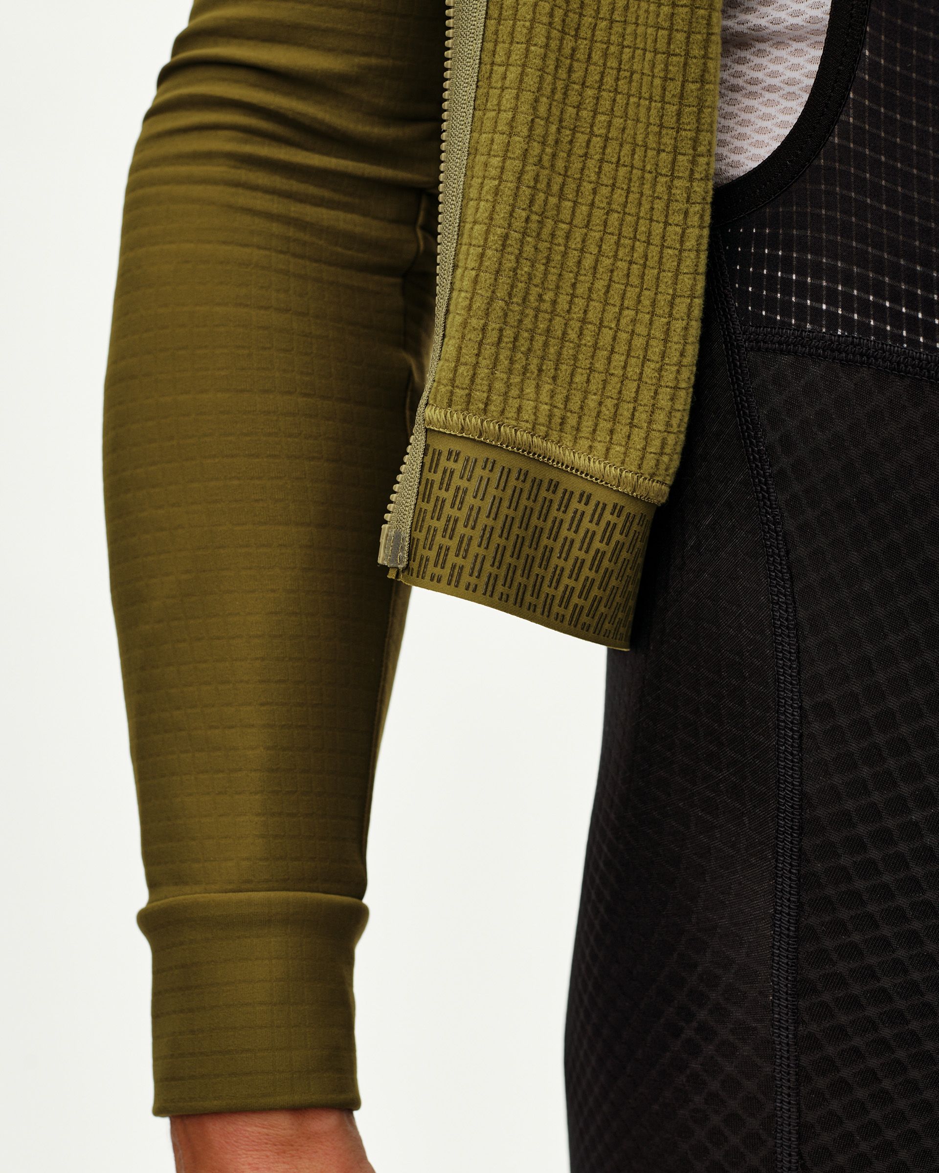 Khaki Green Essential long sleeve cycling jersey, side detail view with printed gripper cuff and zip