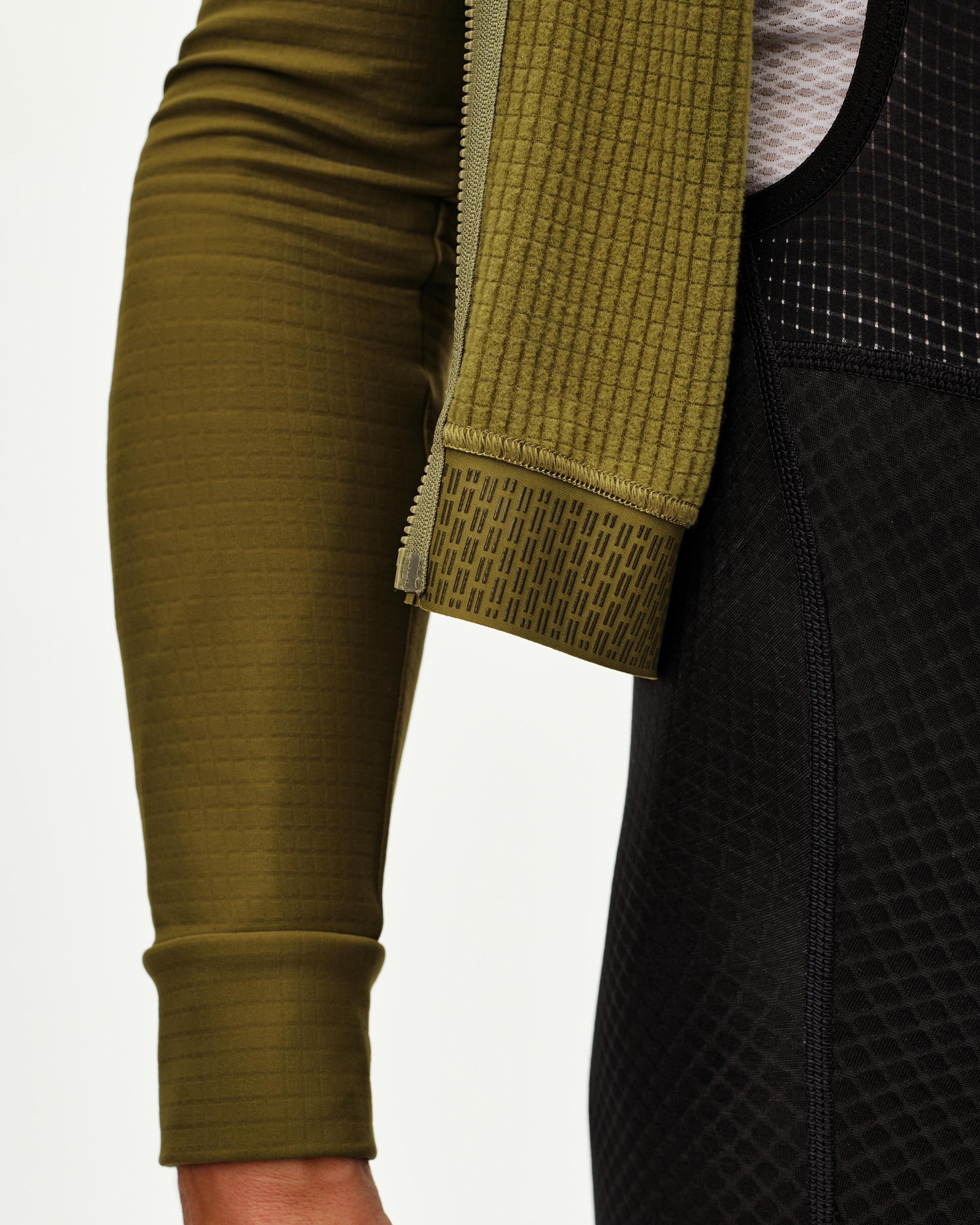 Khaki Green Essential long sleeve cycling jersey, side detail view with printed gripper cuff and zip