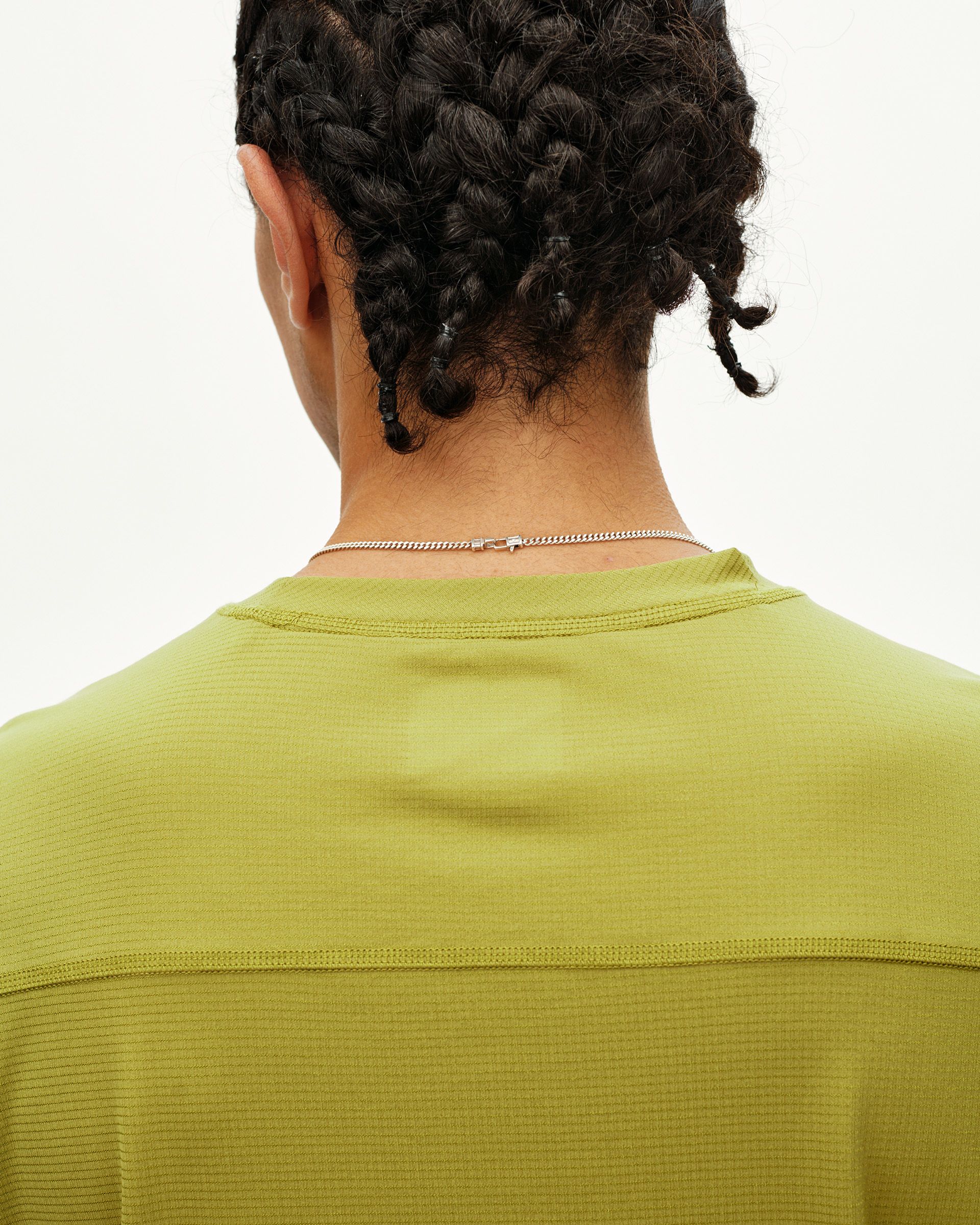 Dark Lime Balance long sleeve T-shirt, rear detail on model showing contrast texture panel at back yoke
