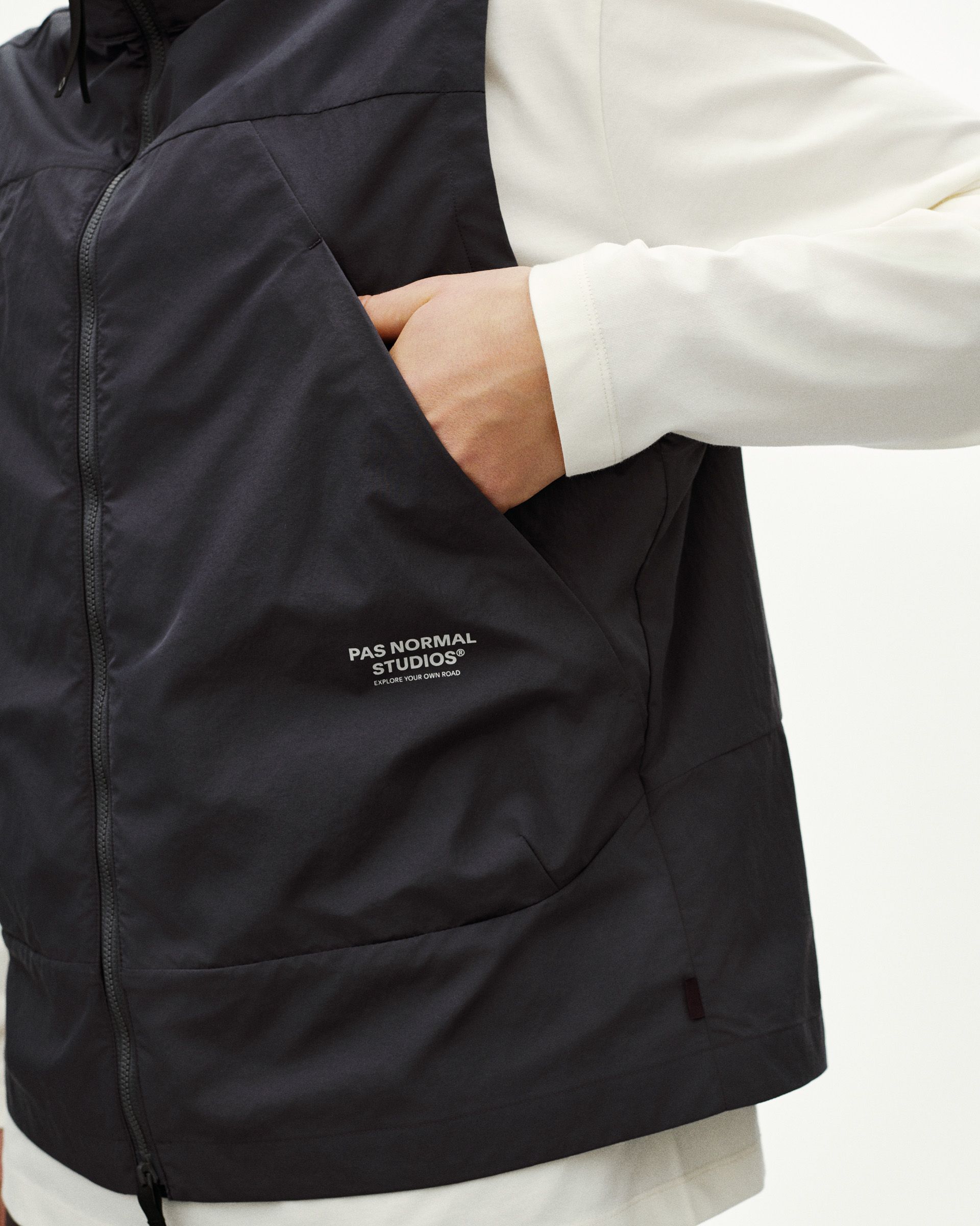 Black Off-Race Utility vest on model showing front zip pockets and white chest logo
