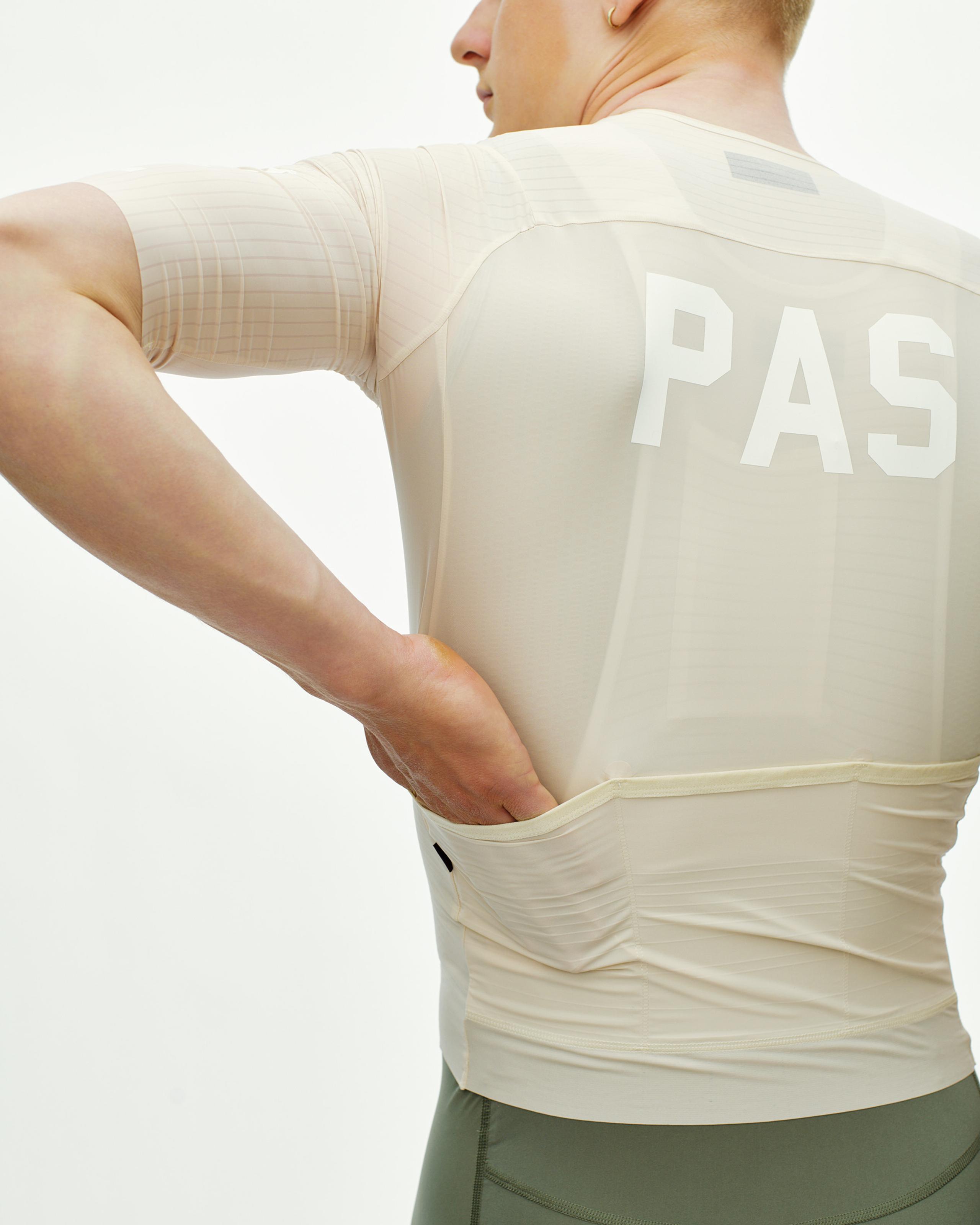 Cream PAS Mechanism Pro cycling jersey on model rear view with white back logo