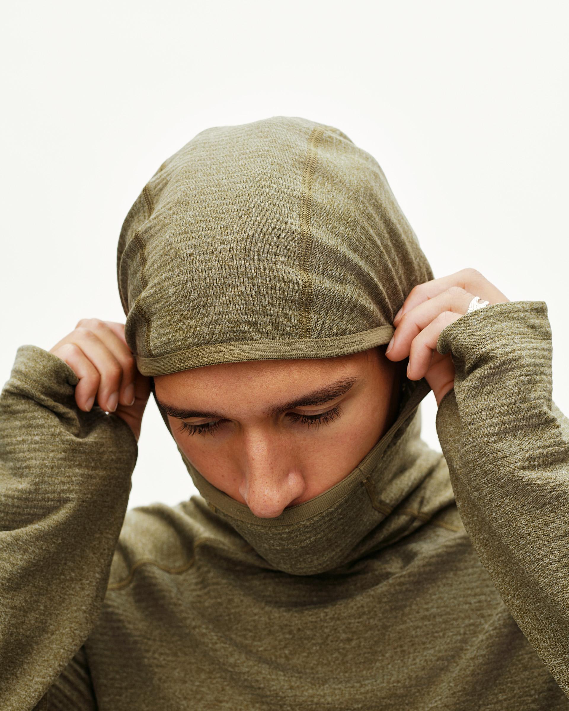 Moss Brown Balance Thermal cycling hoodie on model, front view with balaclava-style hood pulled up