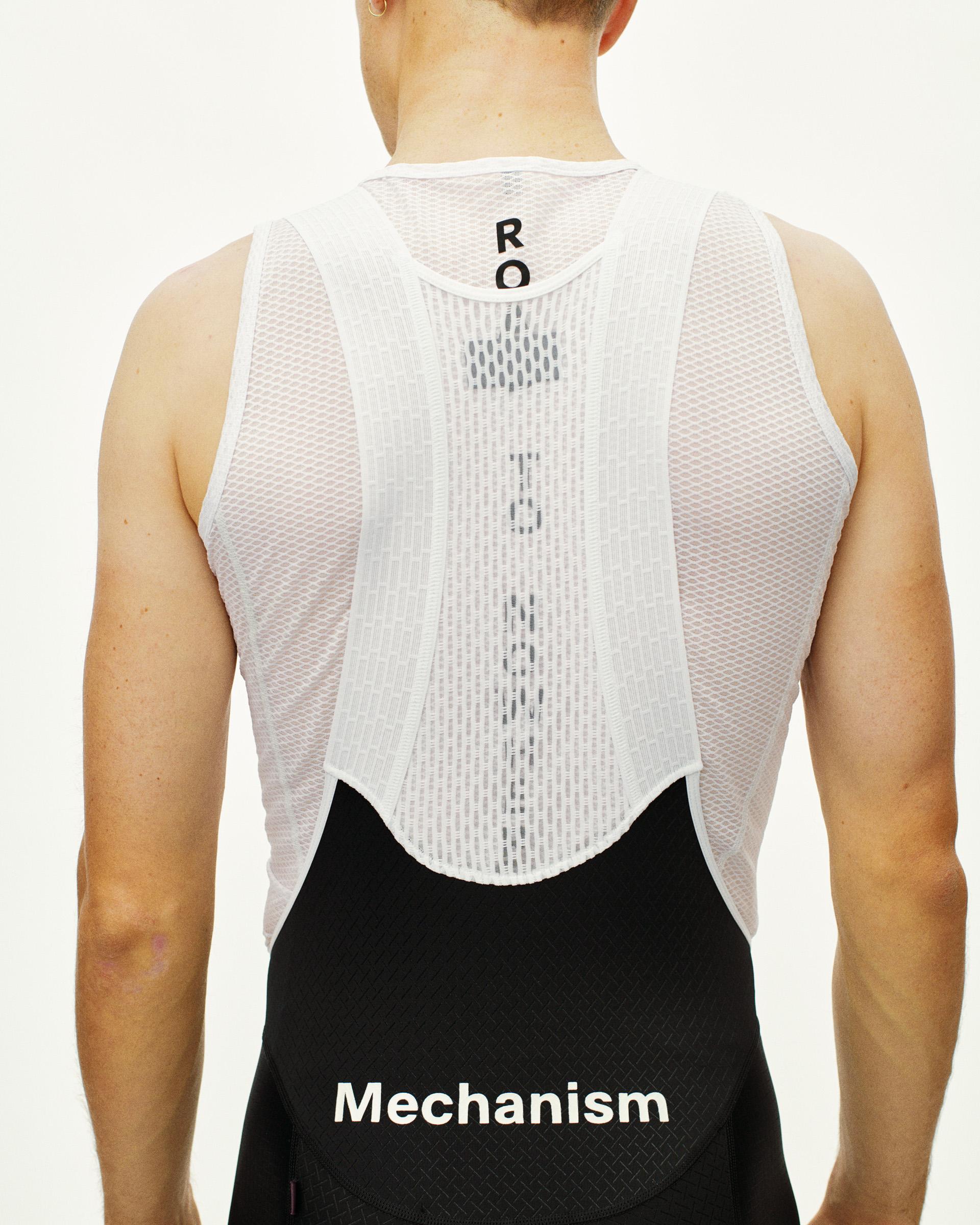 Black Mechanism cycling bibs on model, rear view with white mesh back panel