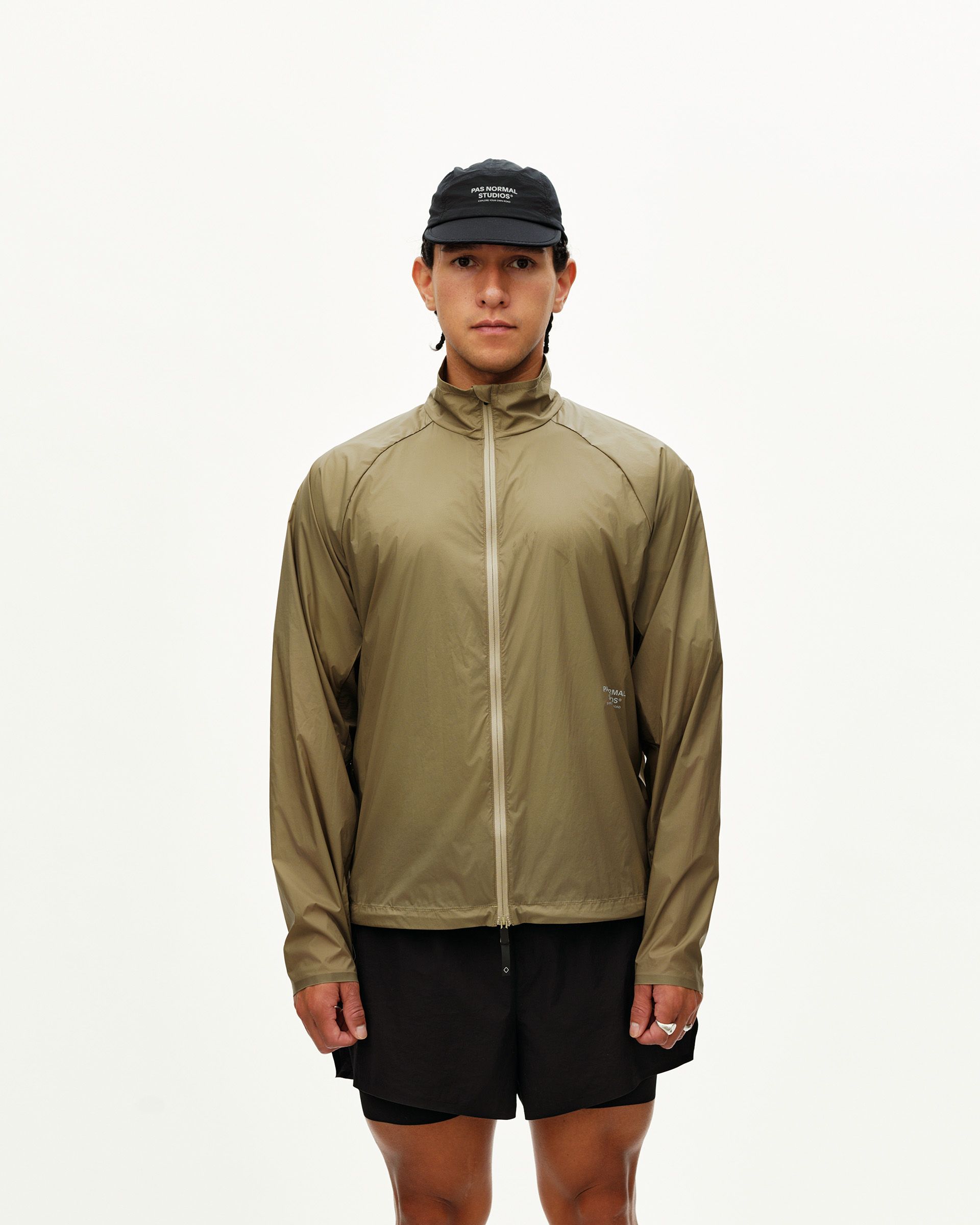 Dusty Earth khaki Balance Windproof jacket on model, front view with full zip and mock neck