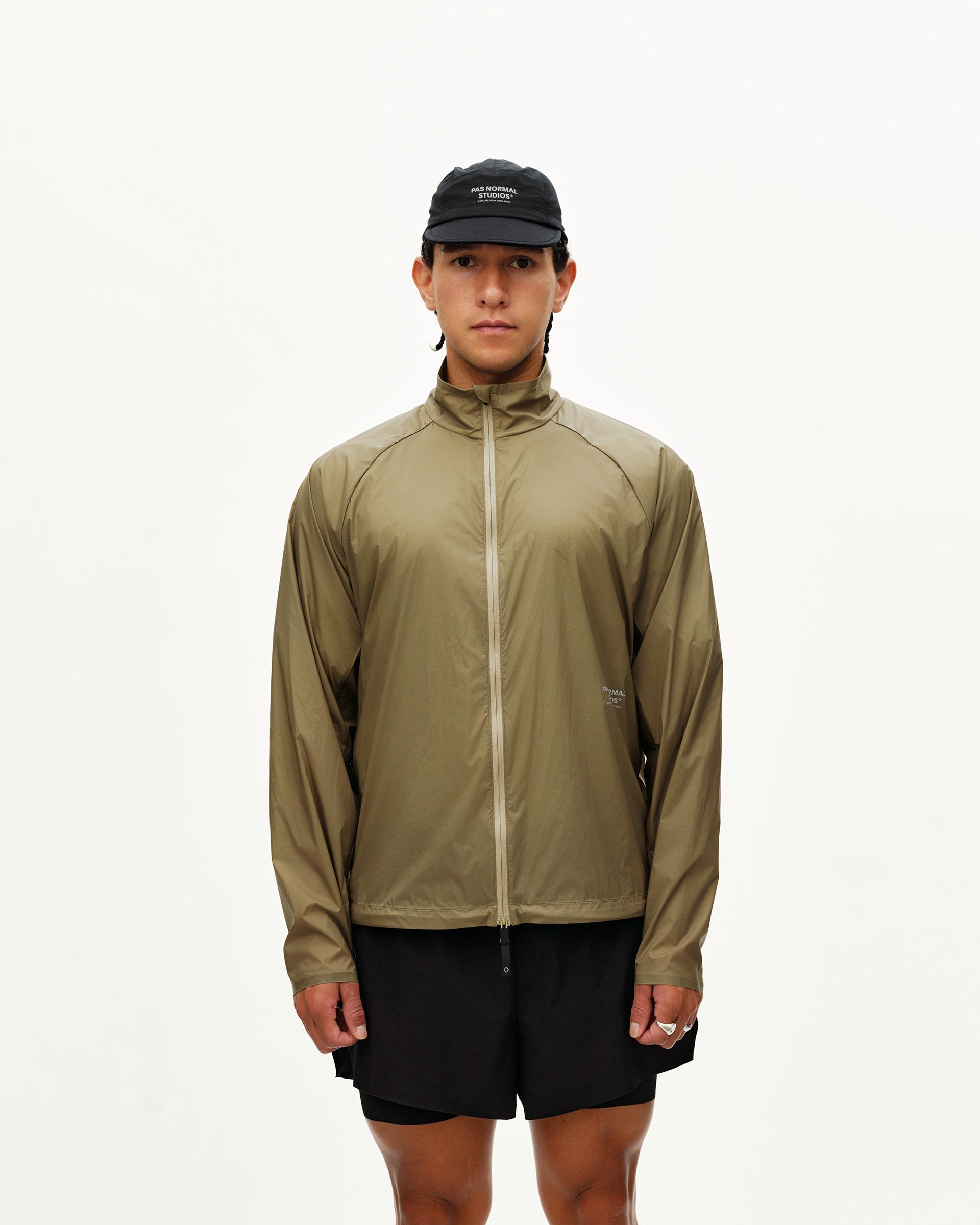 Dusty Earth khaki Balance Windproof jacket on model, front view with full zip and mock neck