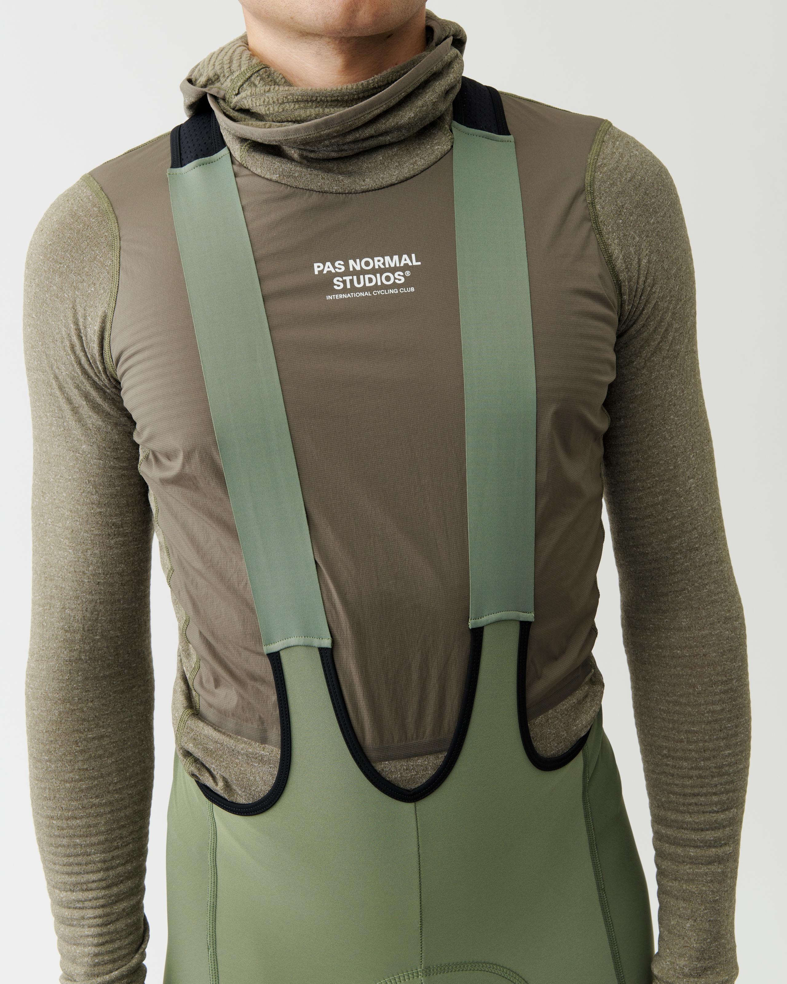 Dark Stone thermal hooded windproof base layer on model, front view with green chest panel and suspender straps