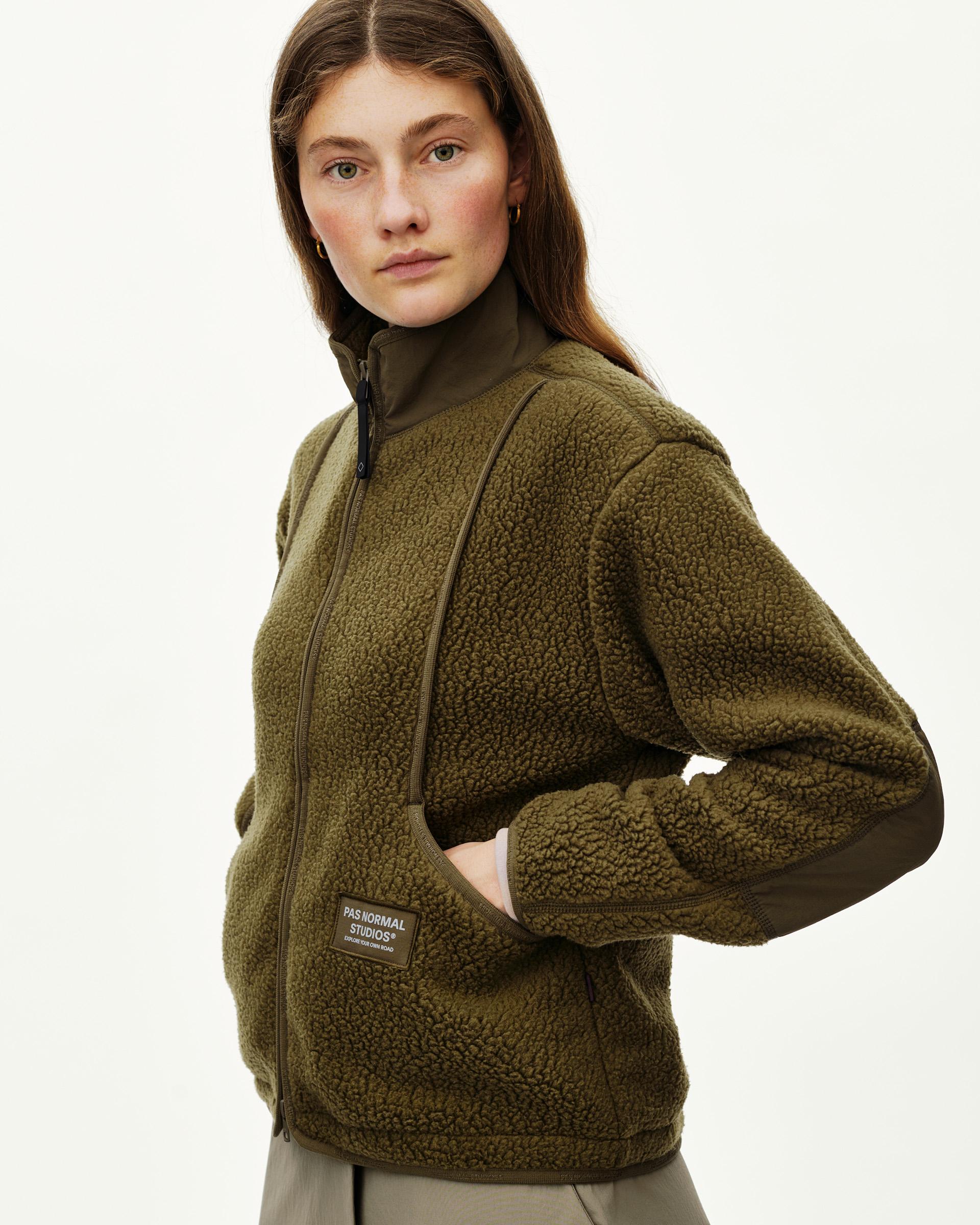 Deep Olive Off-Race Pile Fleece jacket on model, three-quarter front view with full zip and woven label patch