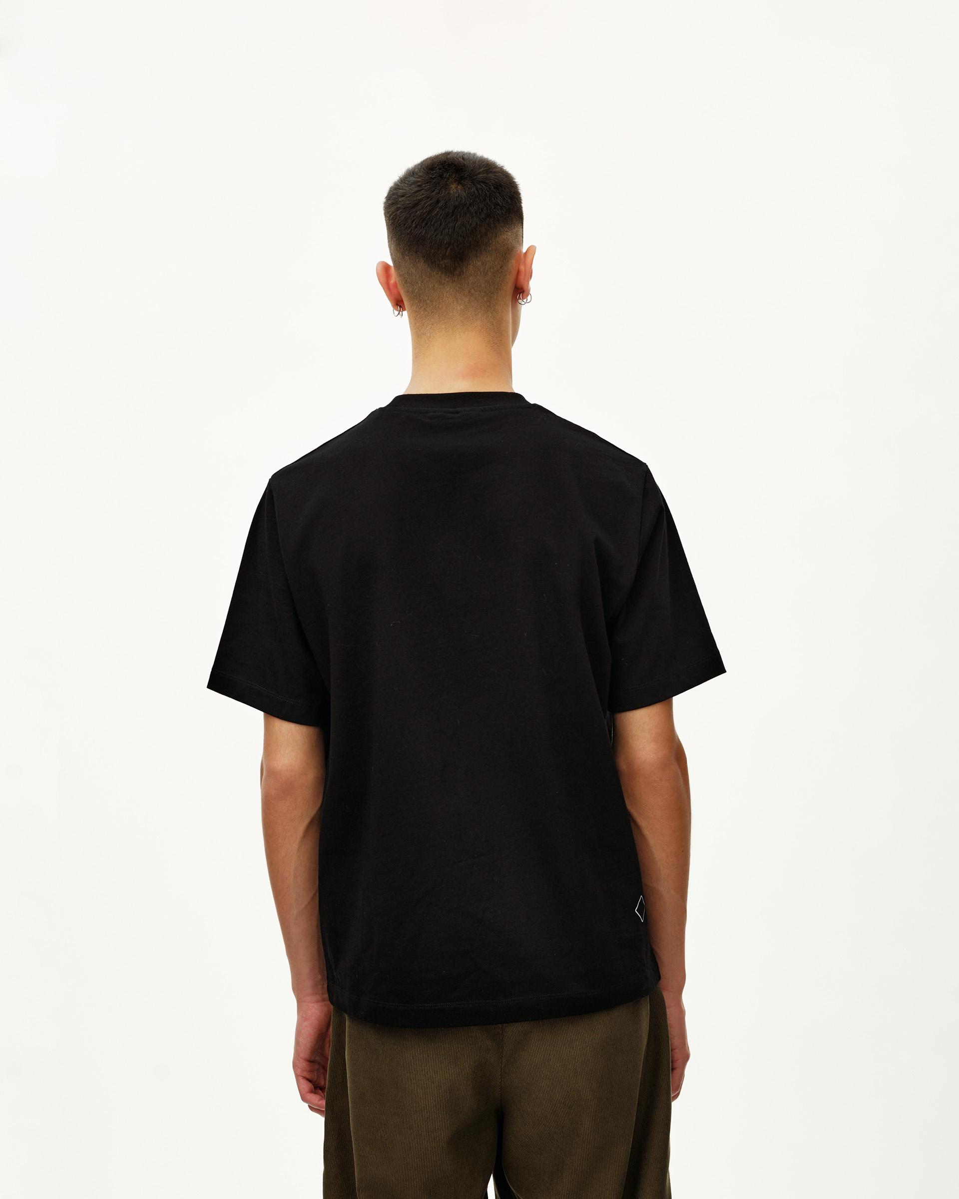 Black Off-Race Graphic T-Shirt, rear view on model with small diamond logo patch at hem