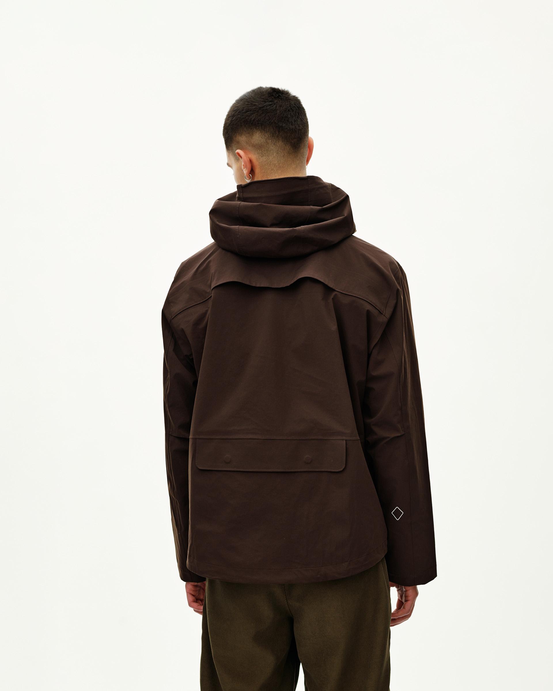 Dark Coffee brown Off-Race 3L Shell jacket on model, rear view with large back pocket and storm hood