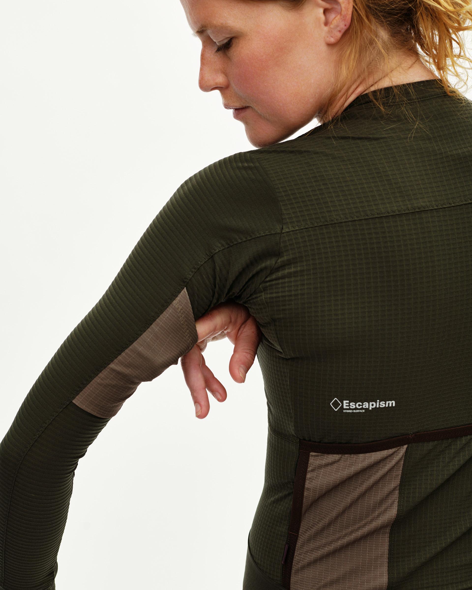 Dark Olive Escapism women's long sleeve cycling jersey, rear detail on model with contrast ripstop panel
