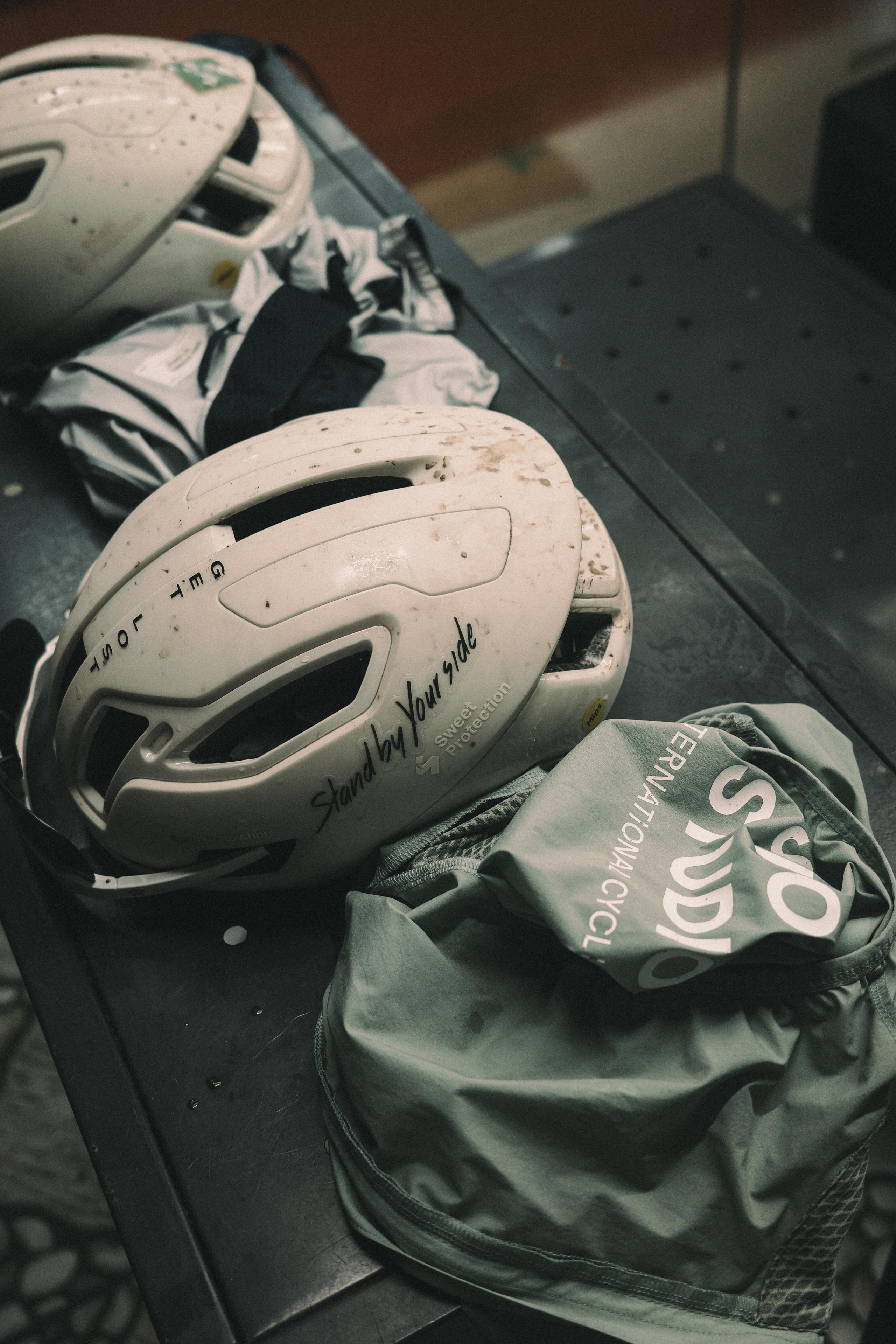 Cycling helmet and gear laid out in car trunk after ride