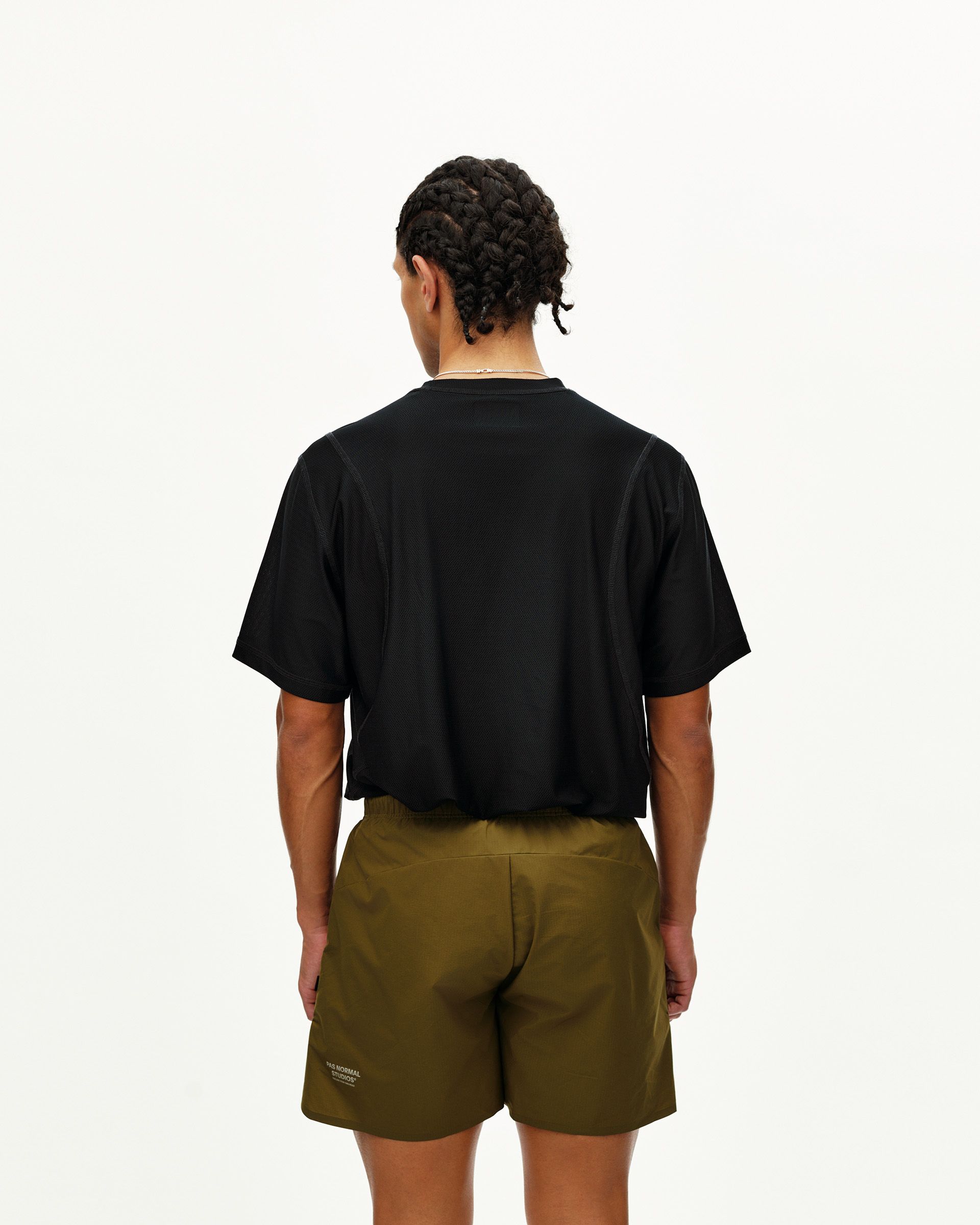 Moss Brown Balance shorts on model, rear view with elastic waistband