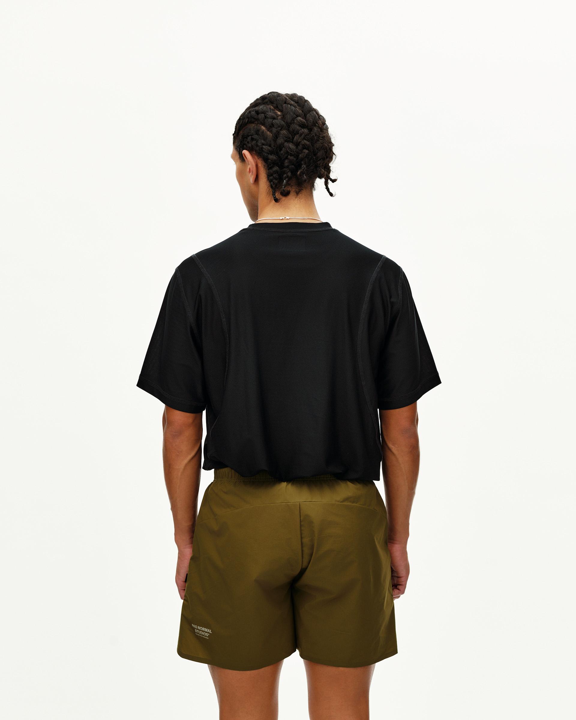 Moss Brown Balance shorts on model, rear view with elastic waistband