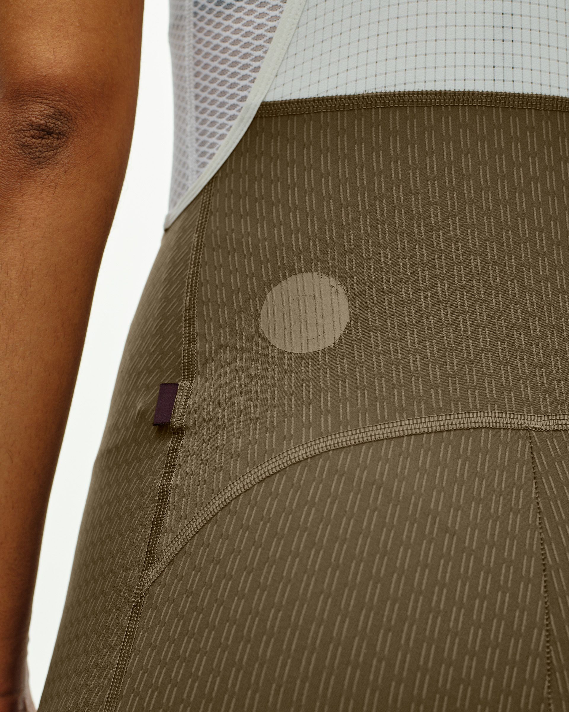 Dark Stone T.K.O. Essential Light Cargo cycling bibs on model showing side cargo pocket with reflective dot