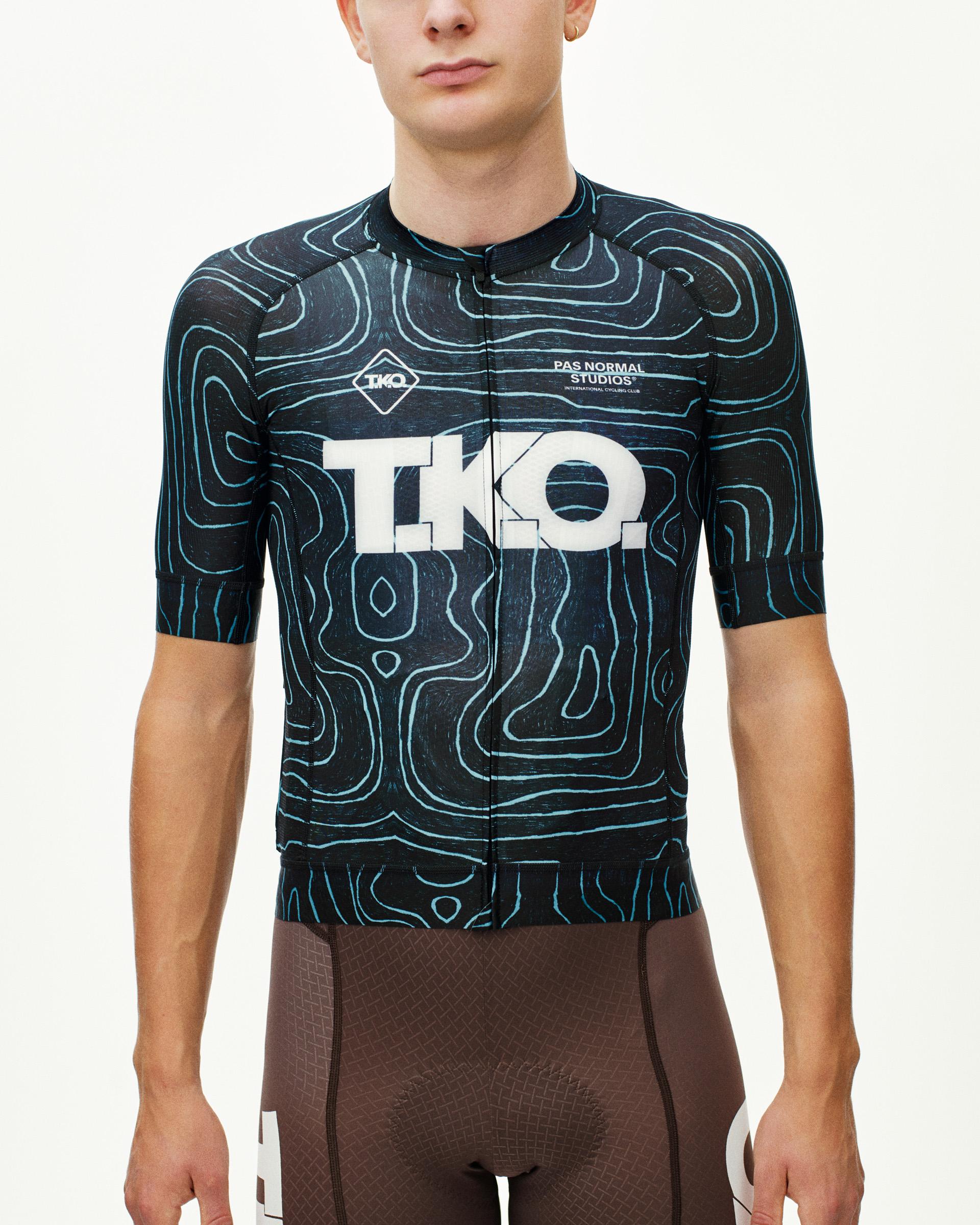 Blue T.K.O. Mechanism cycling jersey on model, front view with topographic print and white chest logo