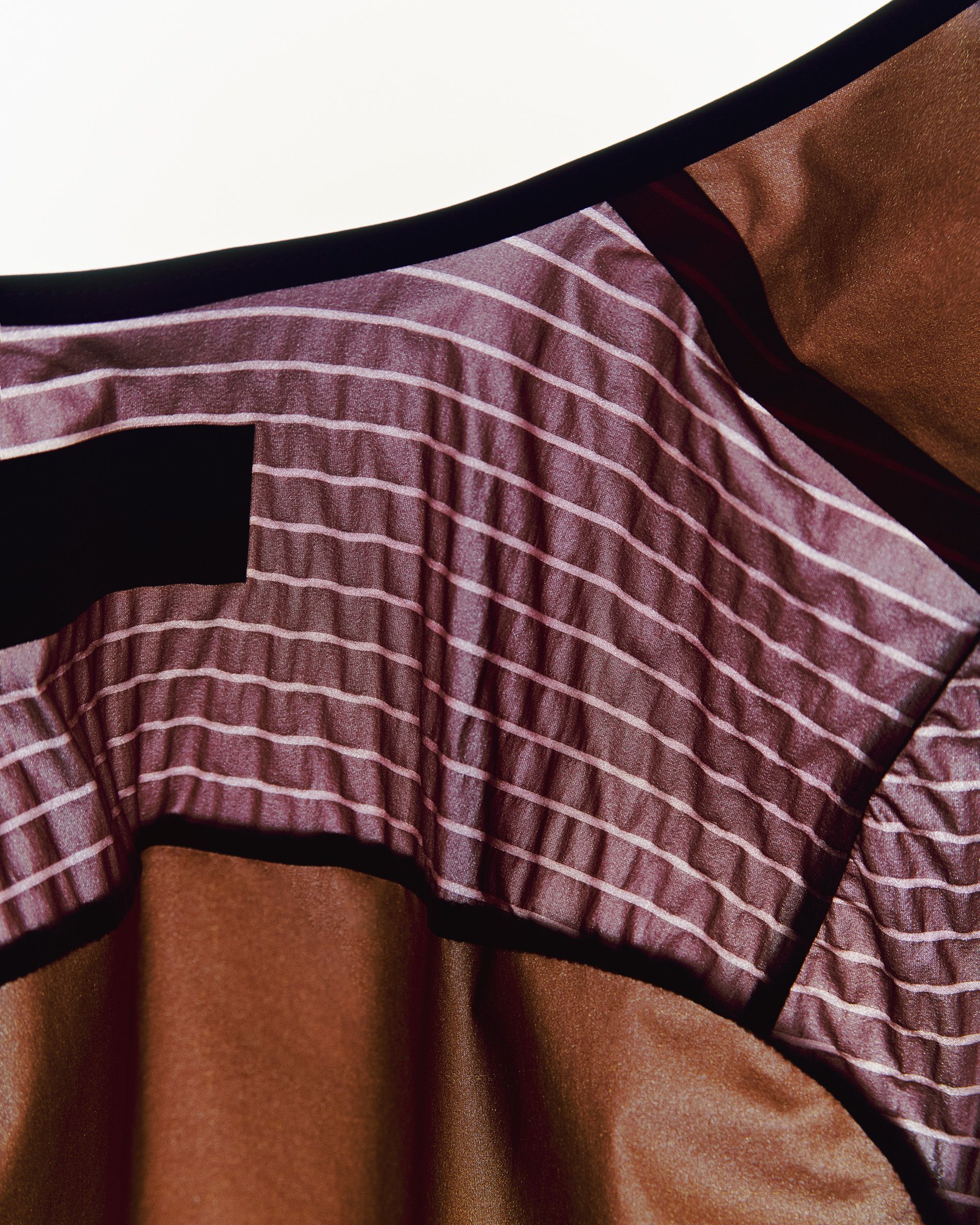 Model wearing purple striped Mechanism Pro jersey with black trim detail