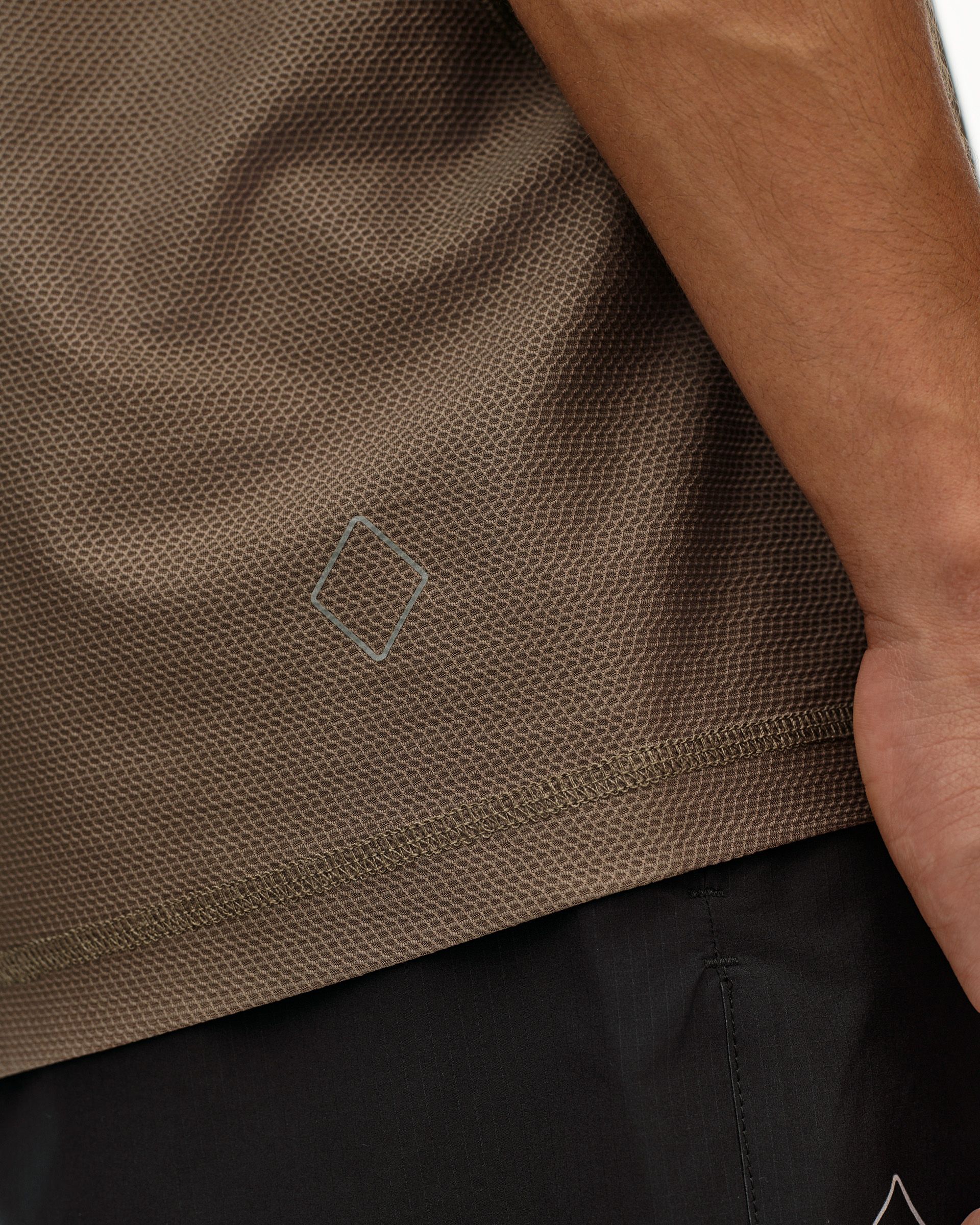 Stone Brown Balance T-shirt, side detail on model showing textured fabric and tonal diamond logo