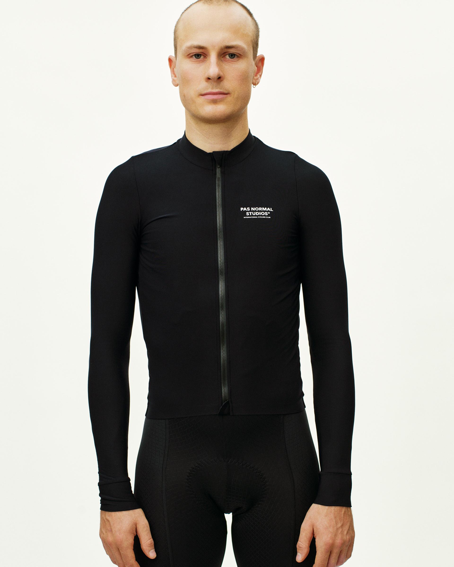 Black Mechanism long sleeve cycling jersey on model, front view with full zip and white chest logo