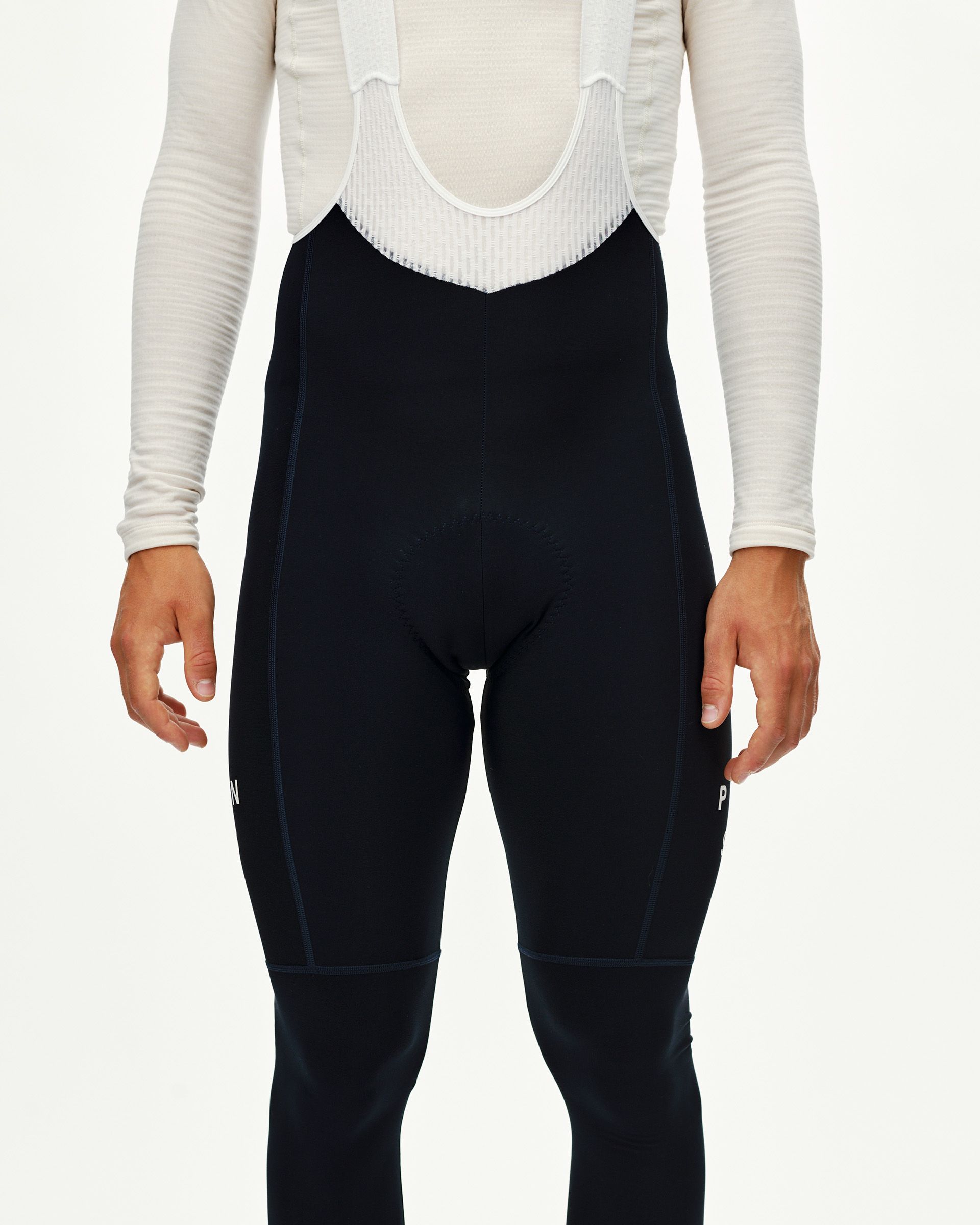 Navy Mechanism cycling thermal long bibs on model, front view with white bib straps and tonal seam detail