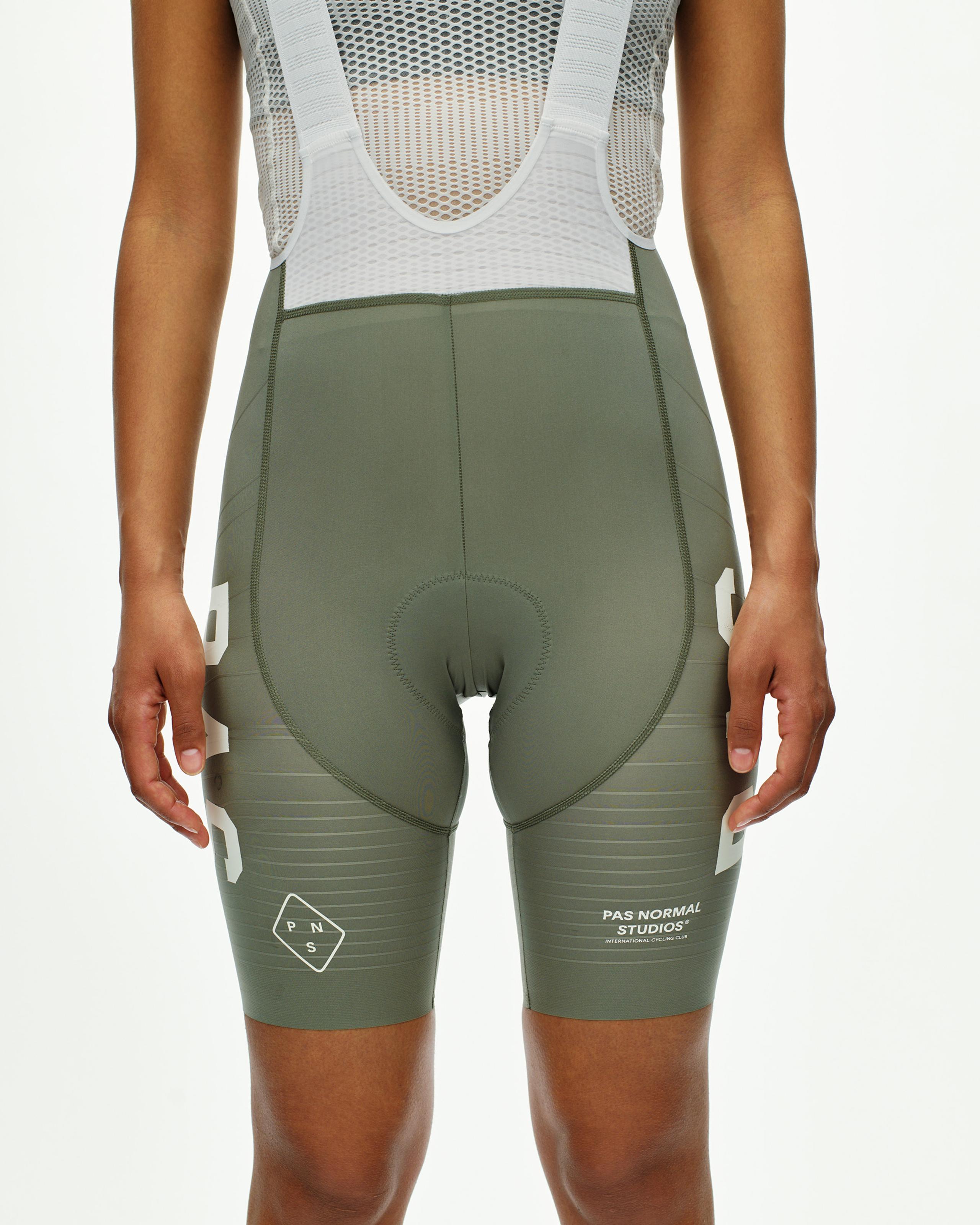 Grey Moss PAS Mechanism Pro cycling bibs on model with white mesh shoulder straps and chamois pad