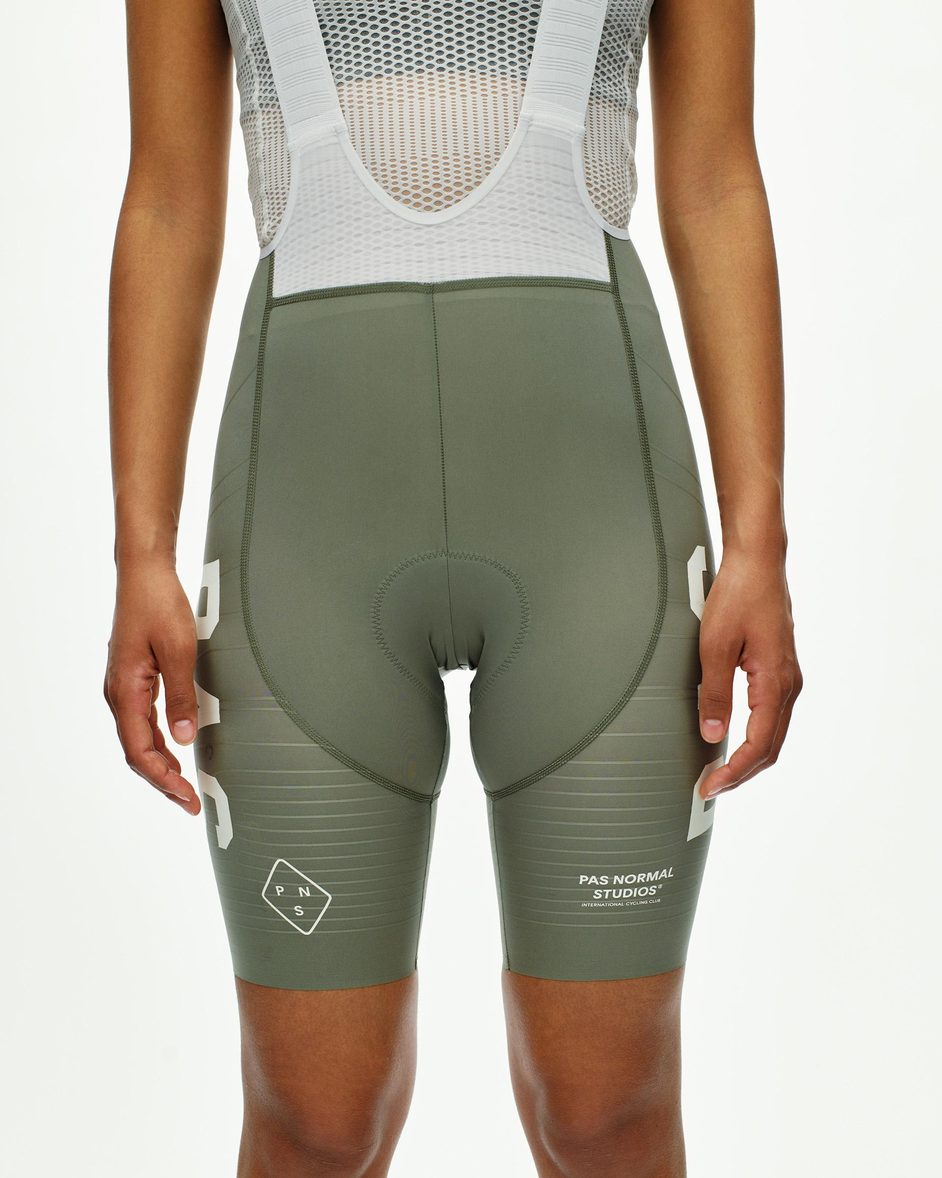 Grey Moss PAS Mechanism Pro cycling bibs on model with white mesh shoulder straps and chamois pad