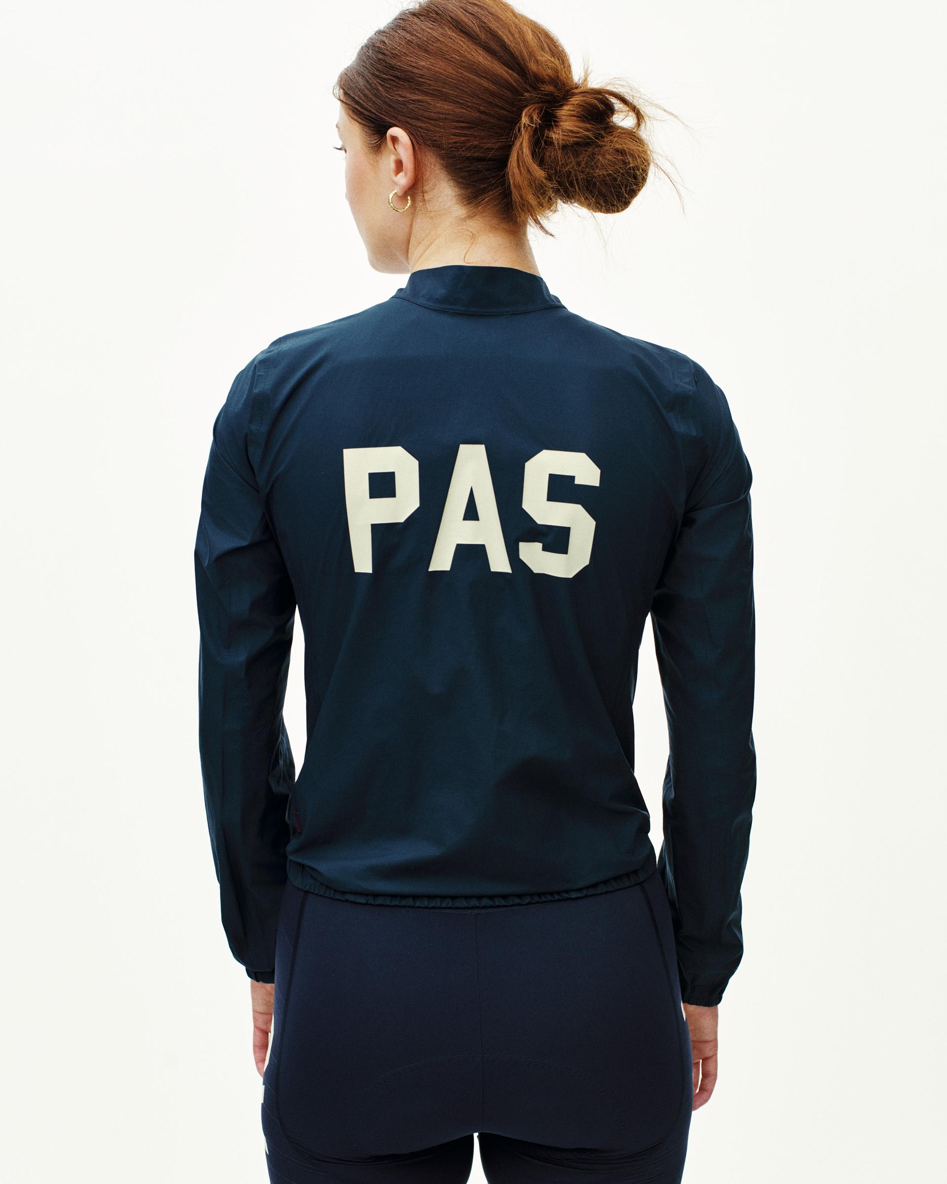 Navy PAS Mechanism rain jacket on model, rear view with white PAS logo