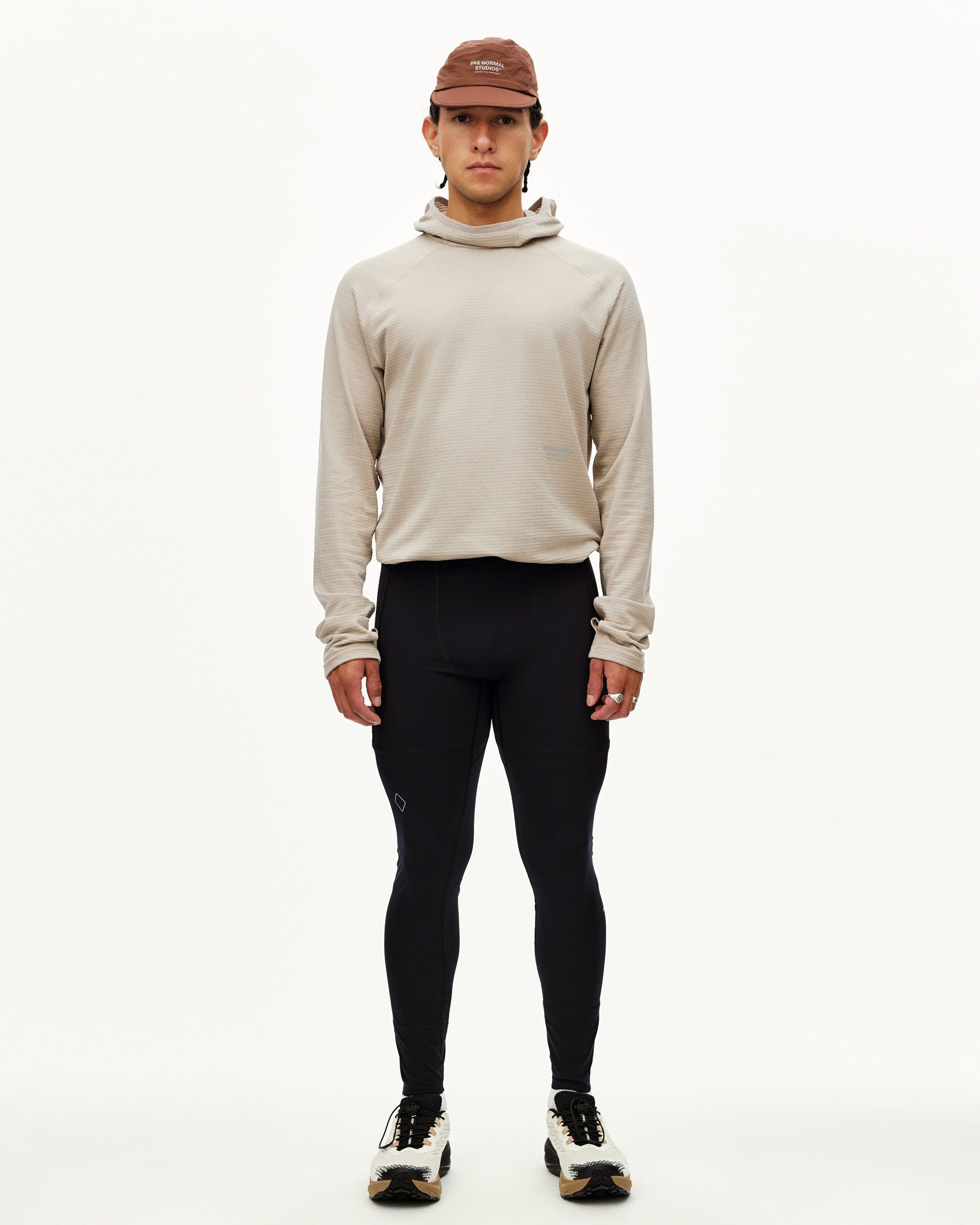 Black Balance Men's Long Tights, front view on model with diamond logo detail at knee