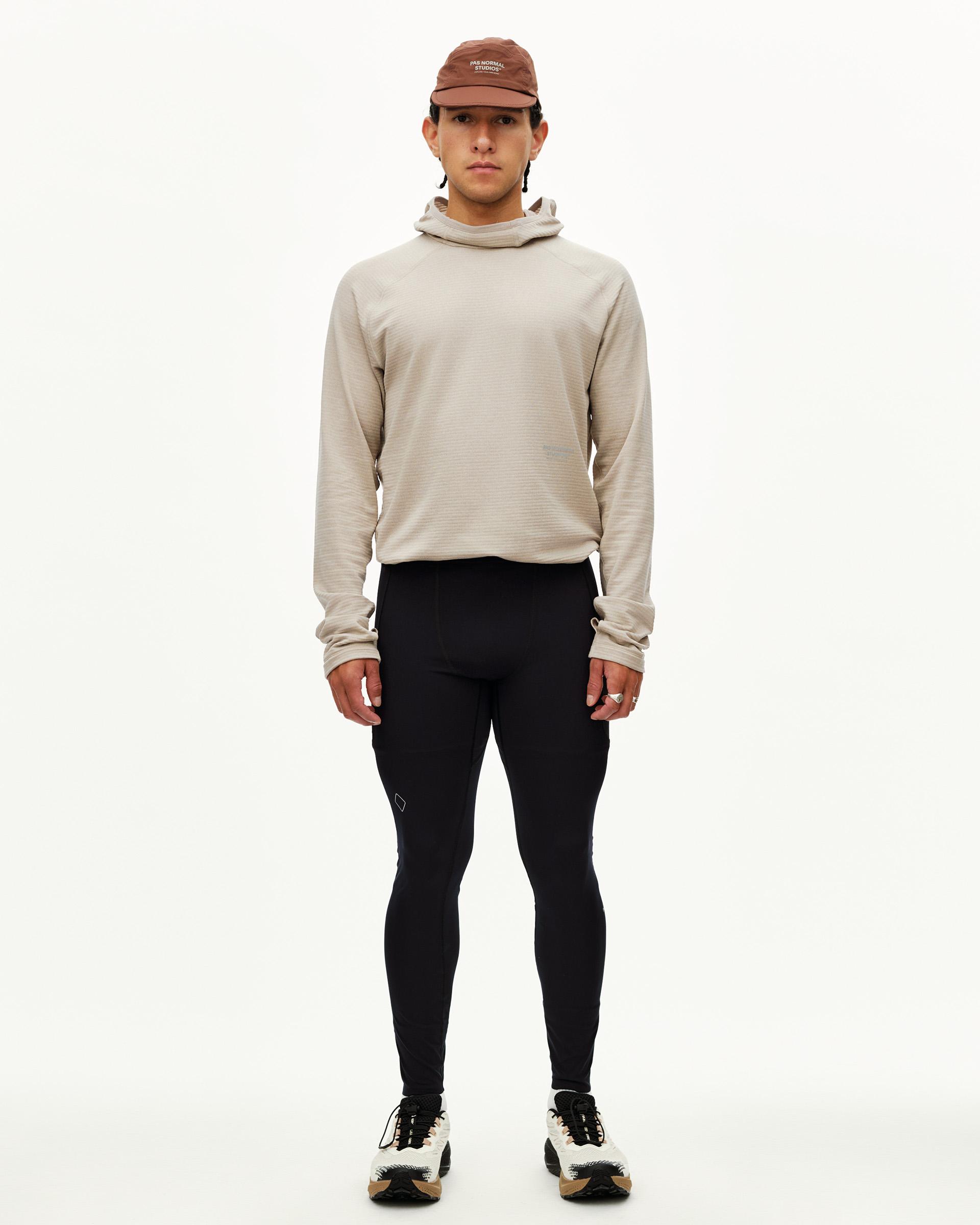 Black Balance Men's Long Tights, front view on model with diamond logo detail at knee